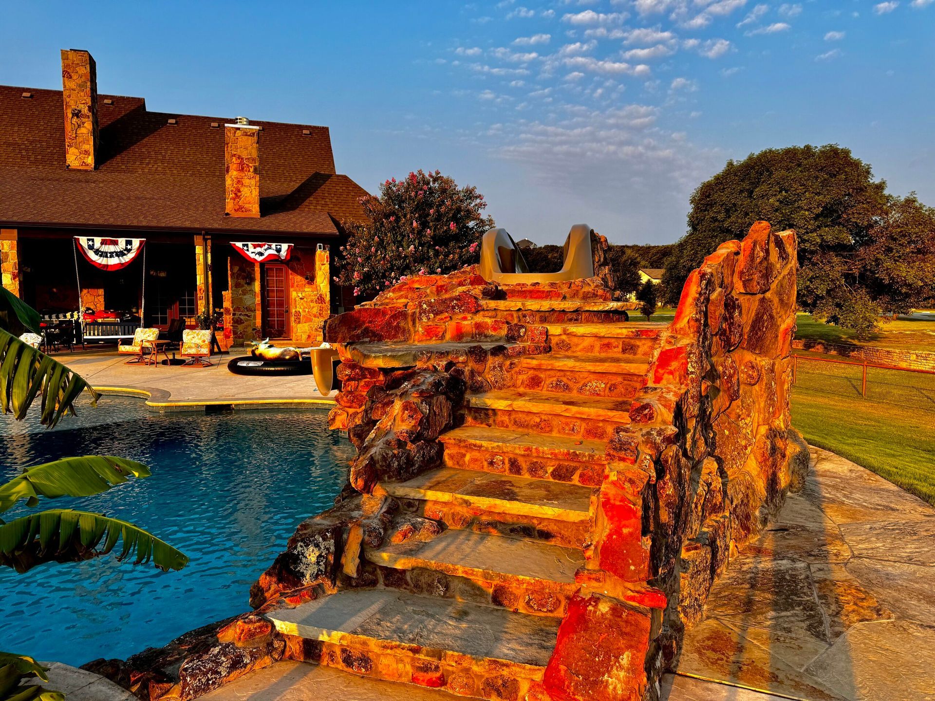 A house with a swimming pool and stairs leading up to it