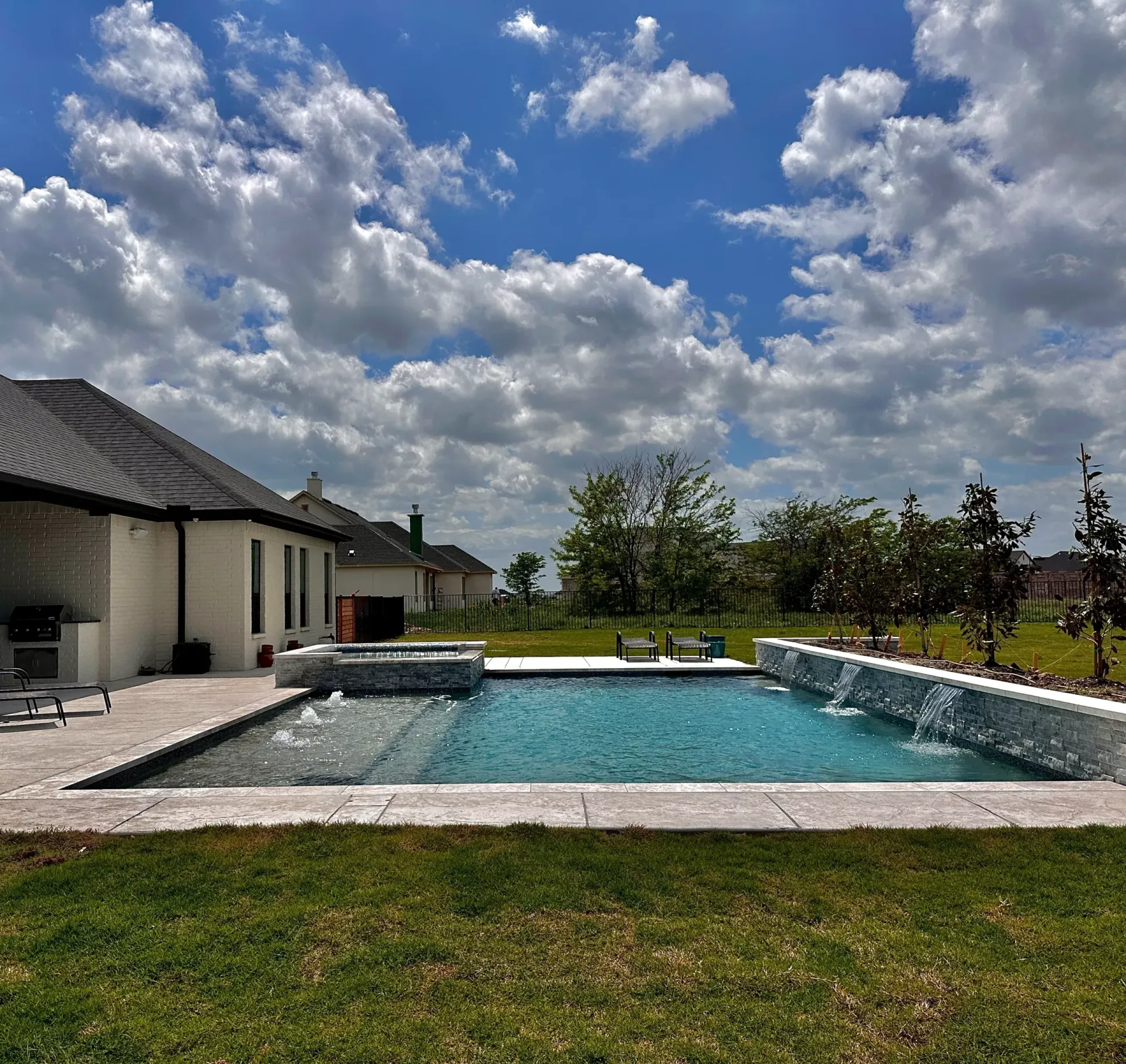 A large swimming pool in the backyard of a house