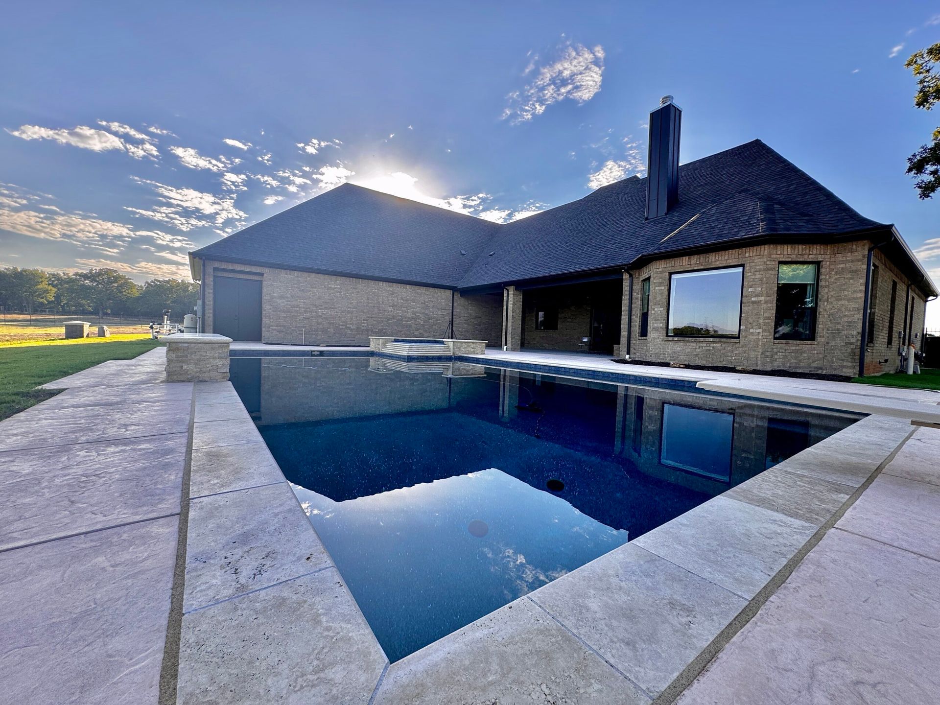 A large house with a large swimming pool in front of it