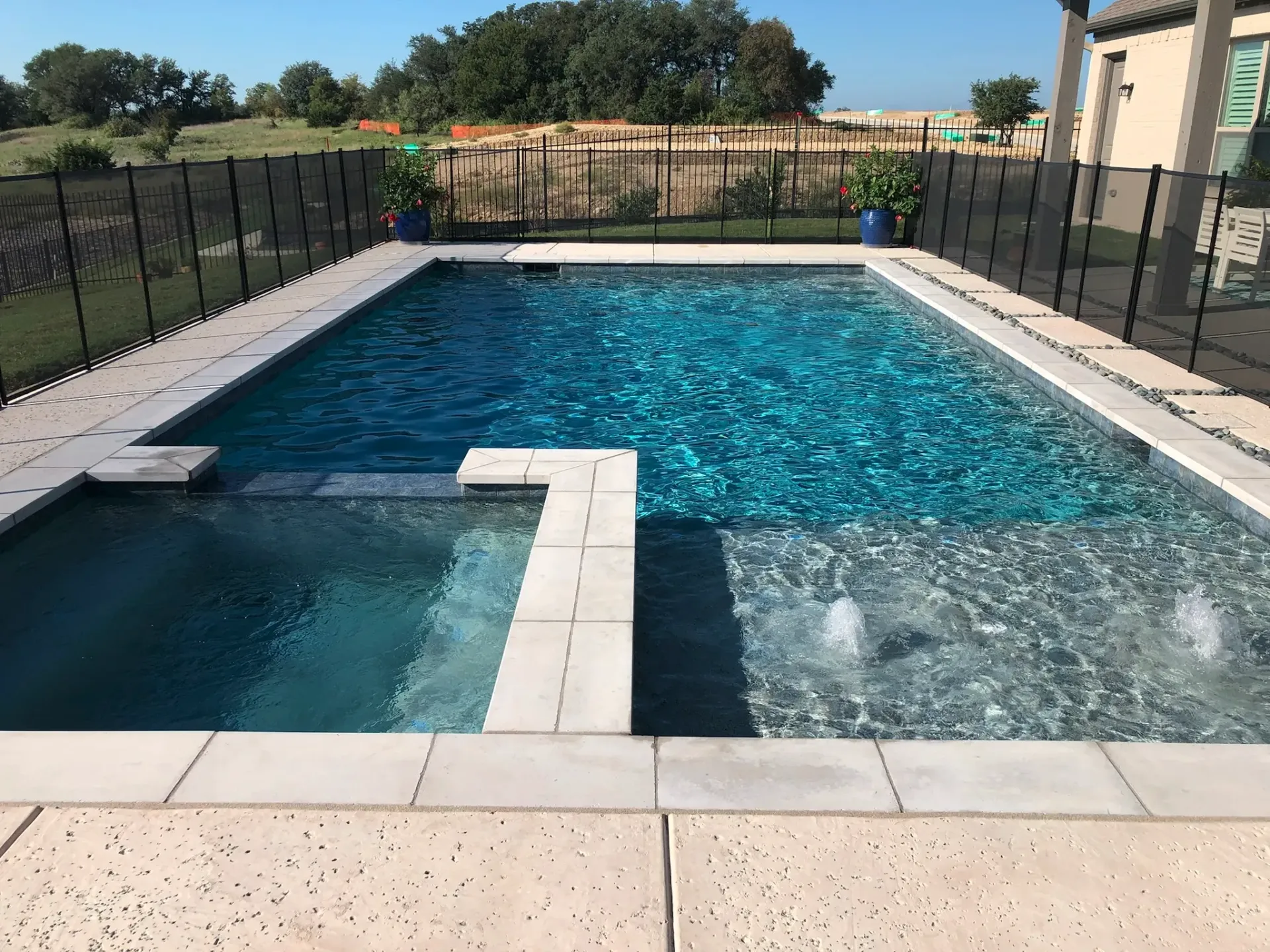 A large swimming pool with a fence around it