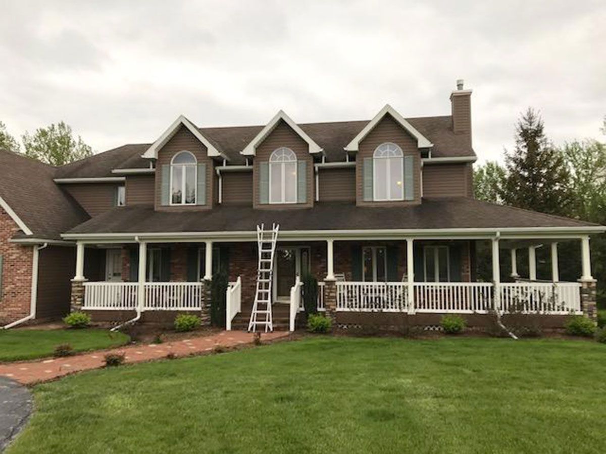 Brown house with white porch and trim