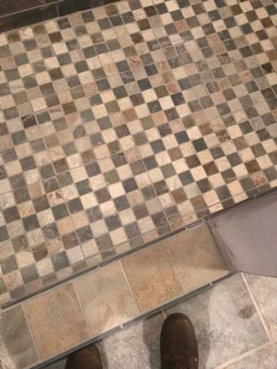 Checkerboard tile floor with a linear drain