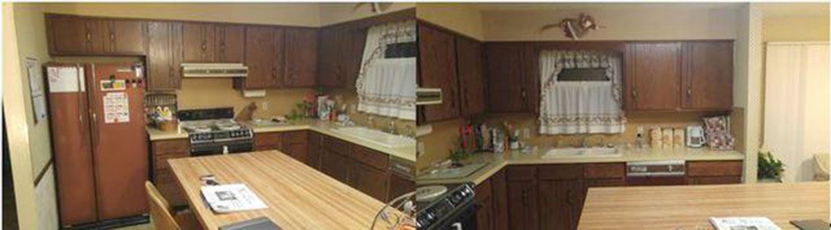 A kitchen with brown cabinets, a refrigerator, stove, and a wooden table