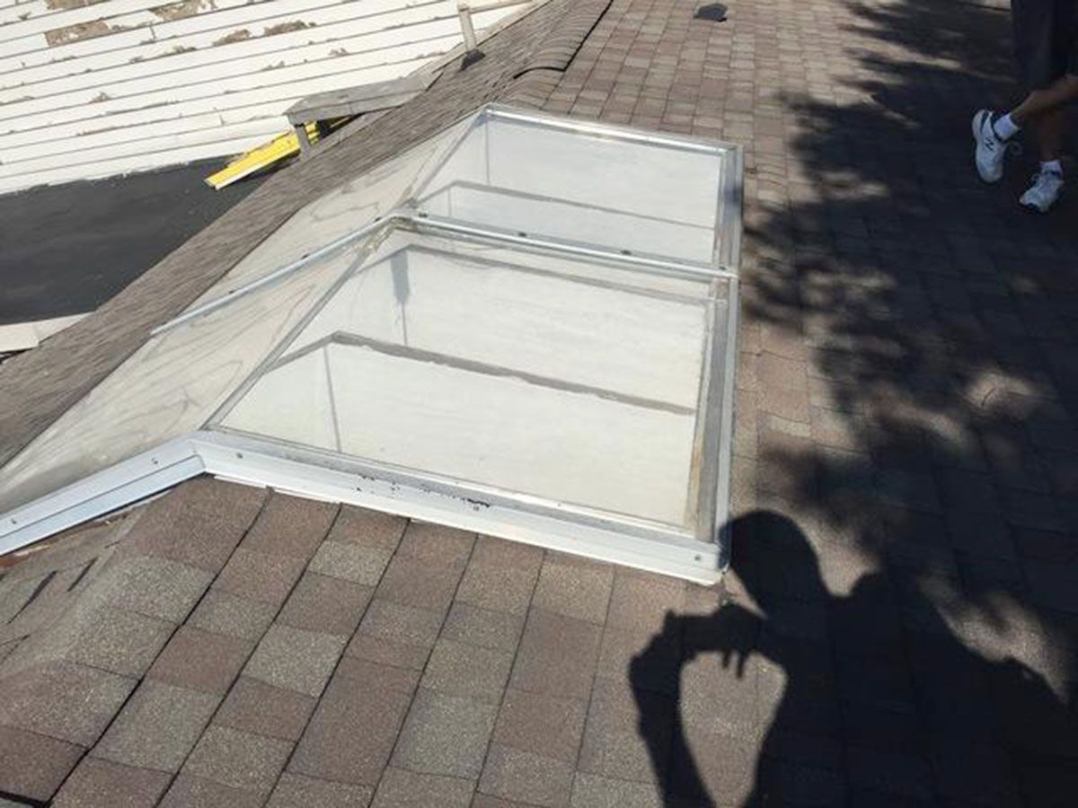 Skylight on a shingled roof, angled view