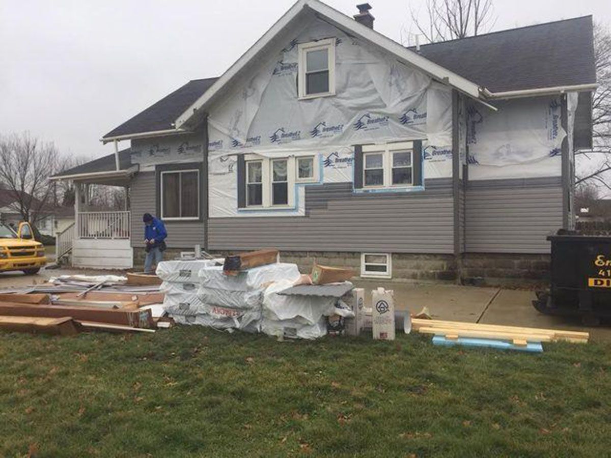 House under renovation; gray siding being installed