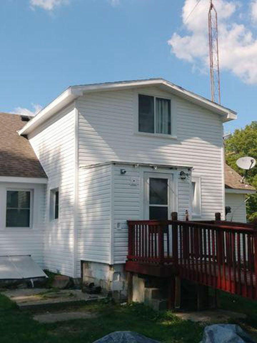 White house with red deck, window, and door