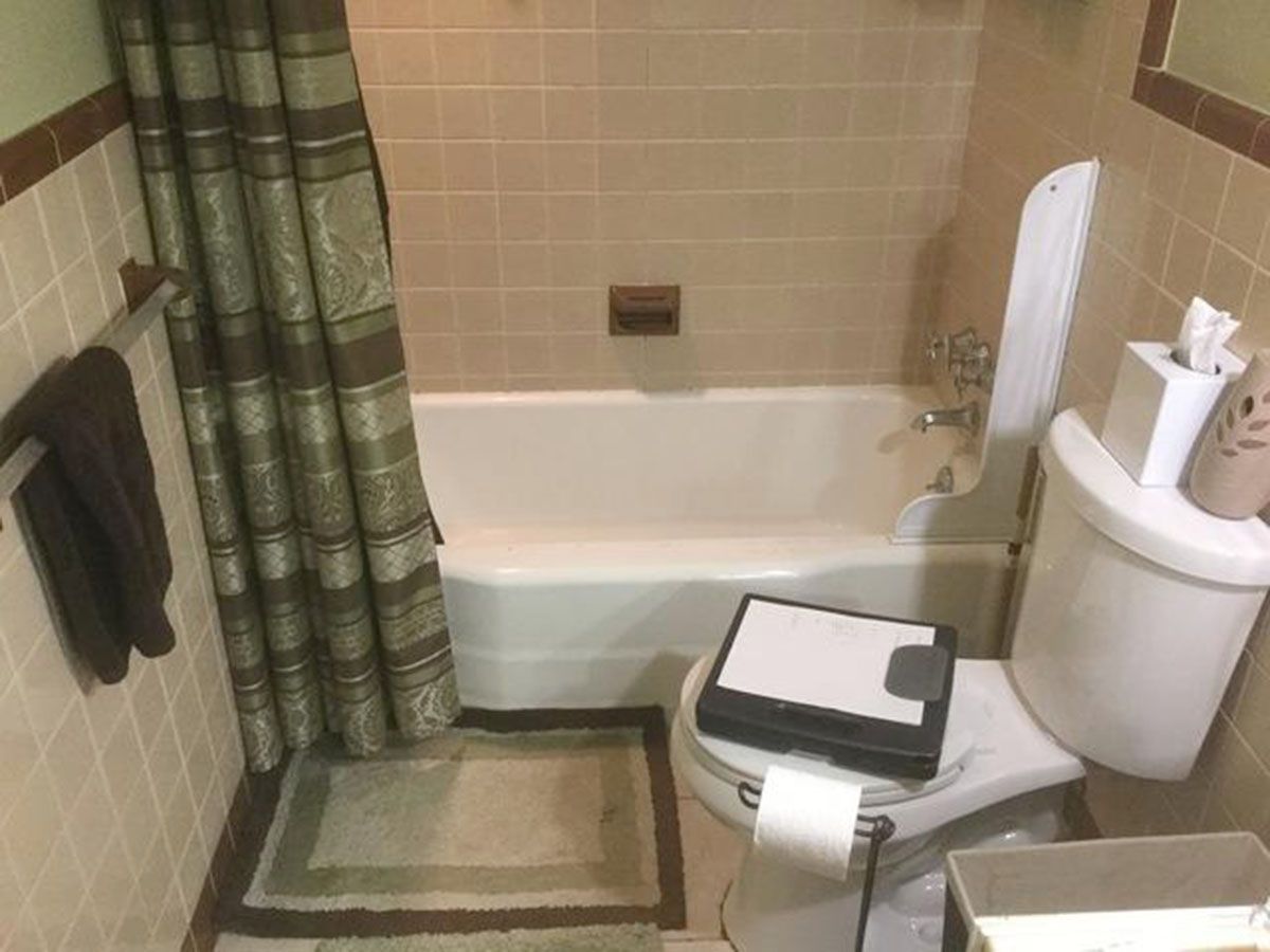 Bathroom with a bathtub, toilet, and patterned shower curtain