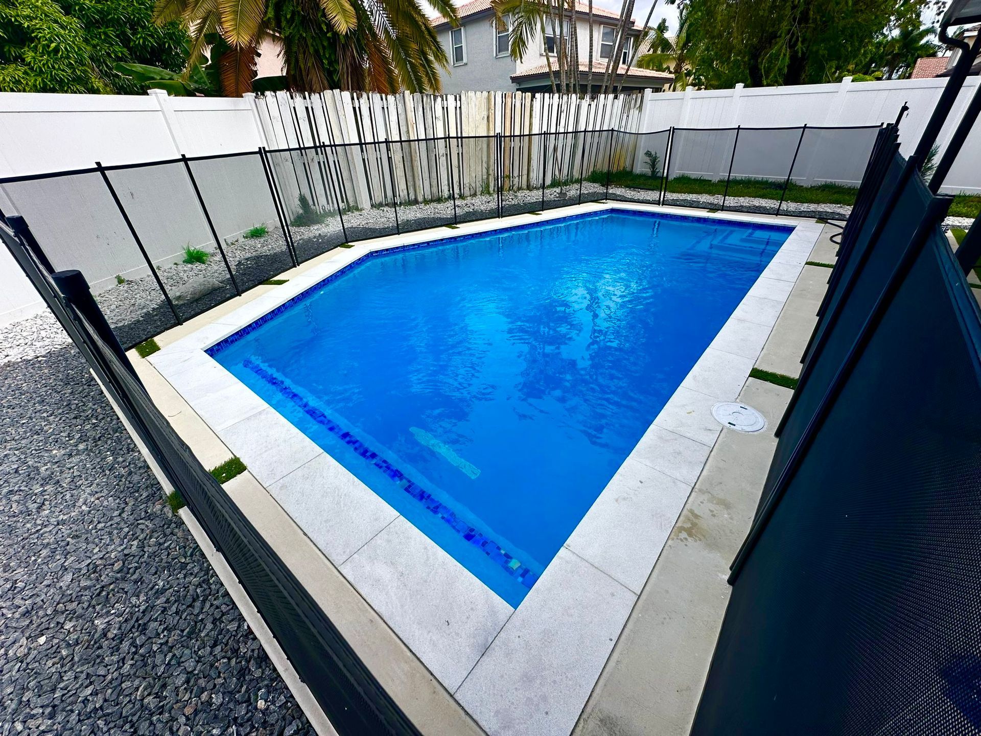 A large swimming pool with a fence around it