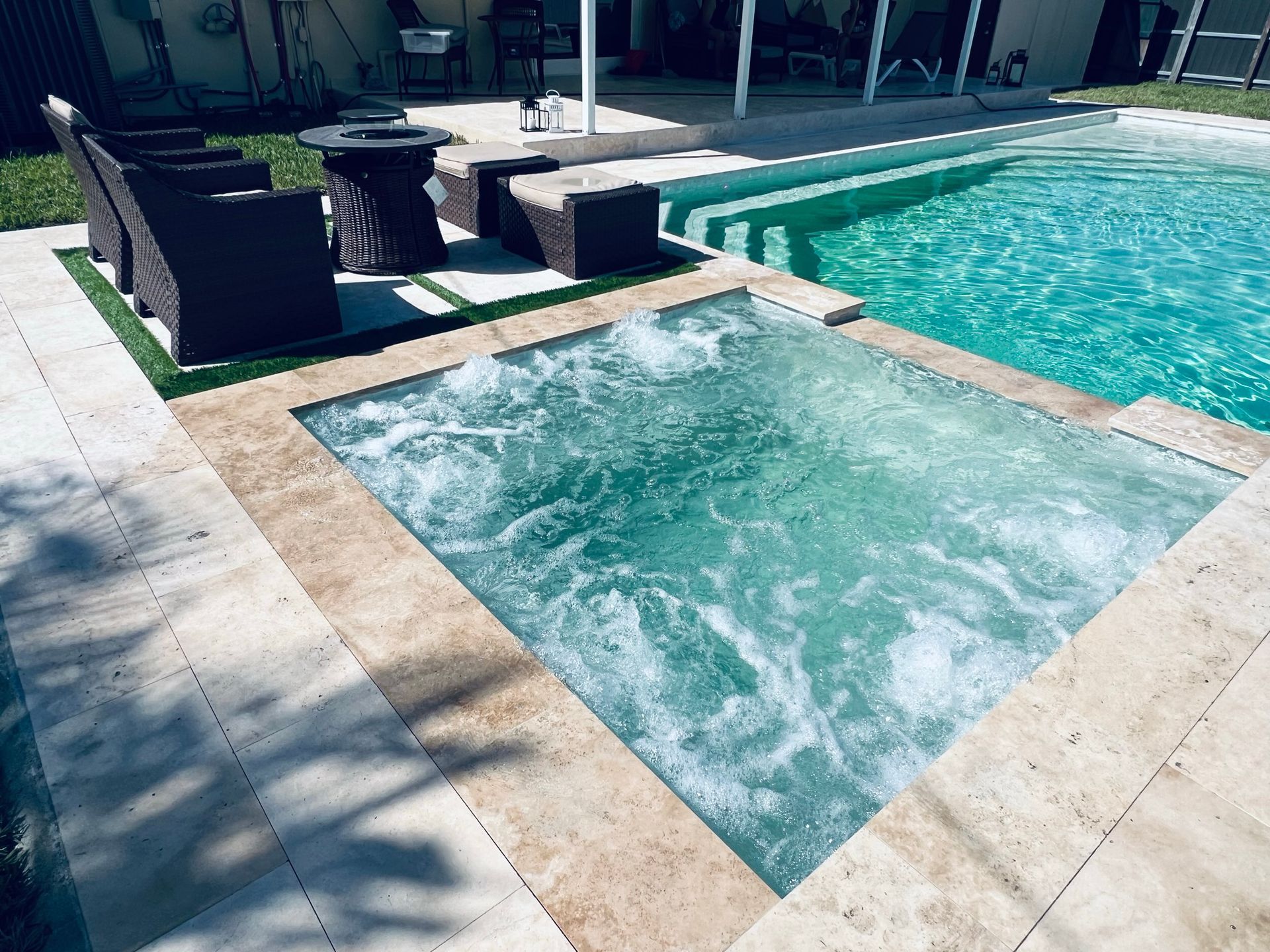 A swimming pool with a hot tub in the middle of it.