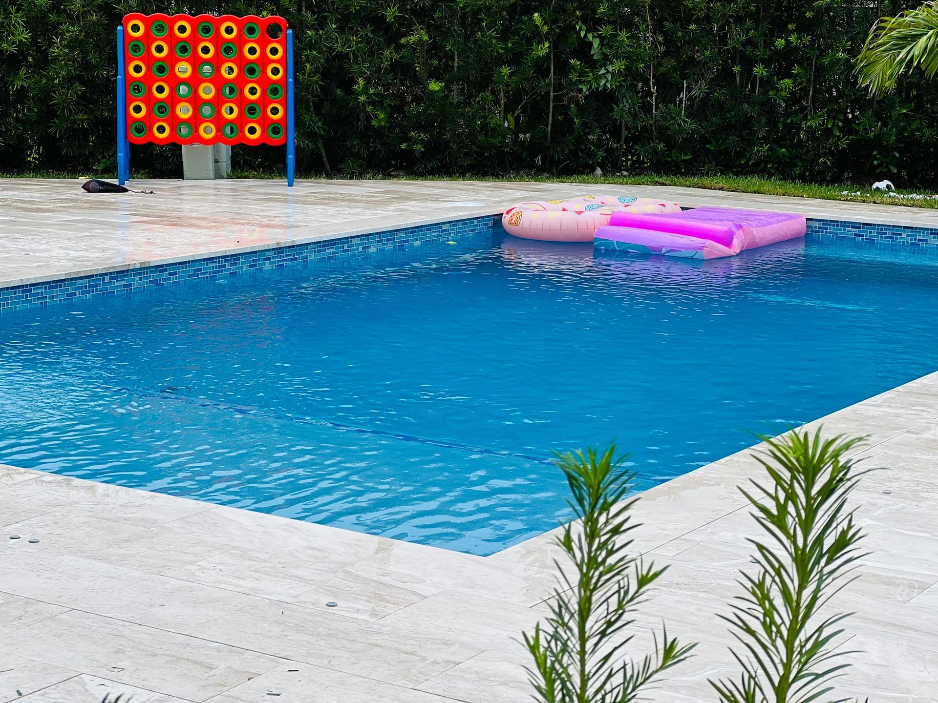 A large swimming pool with a pink float in it