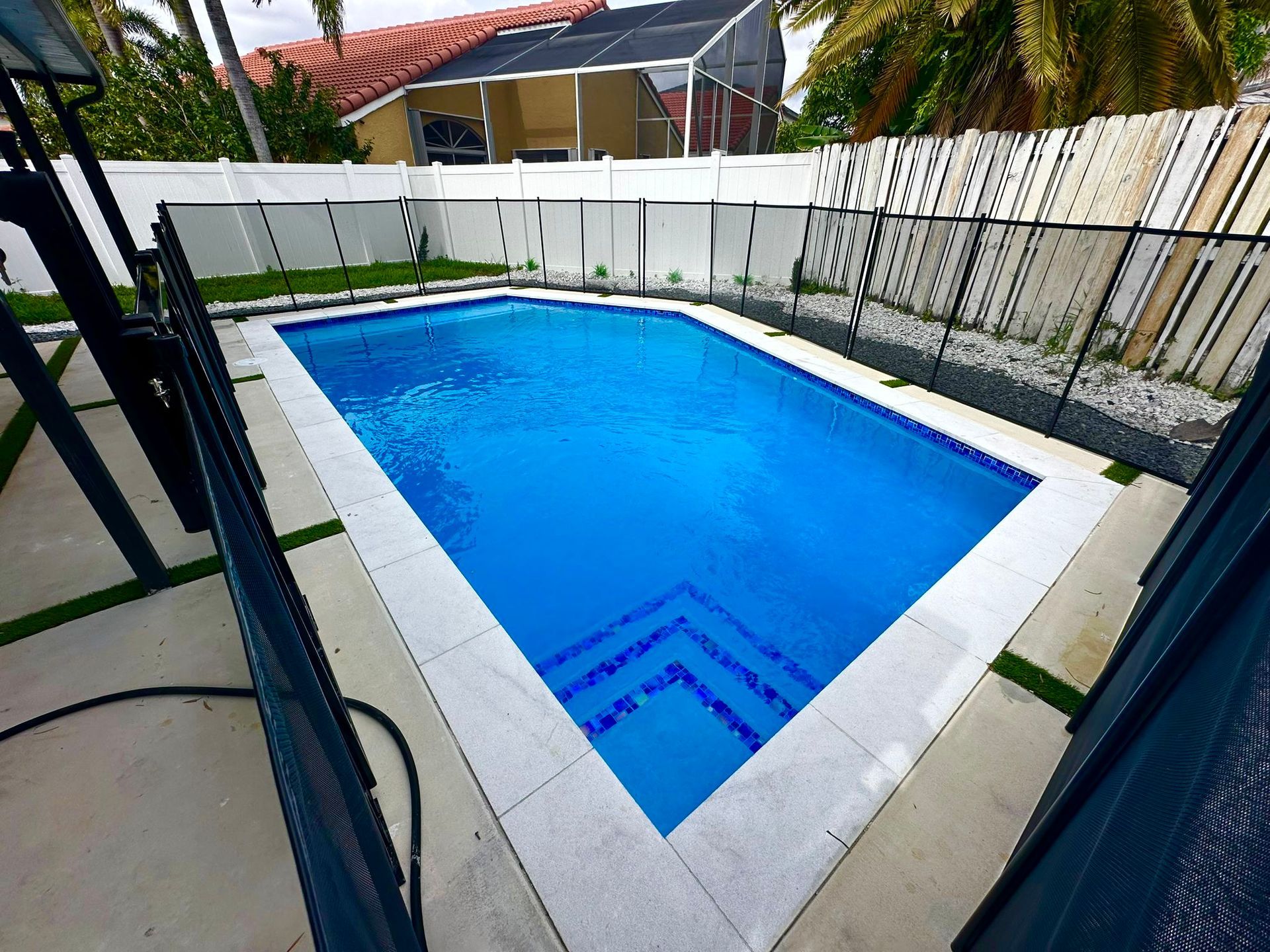 A large swimming pool with a fence around it