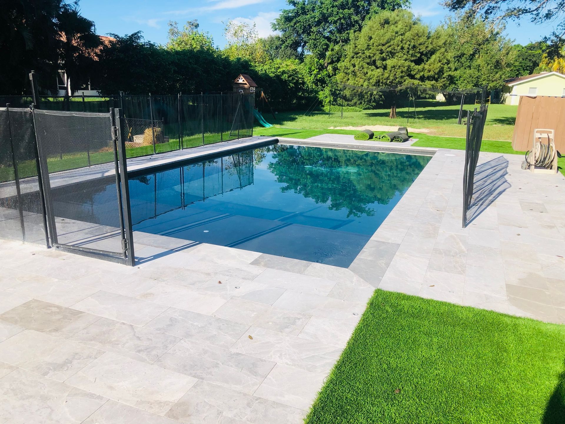 A large swimming pool with a fence around it