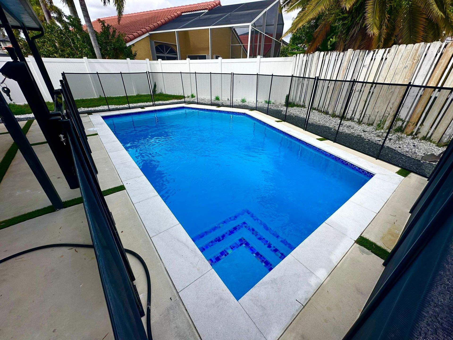A large swimming pool in the backyard of a house