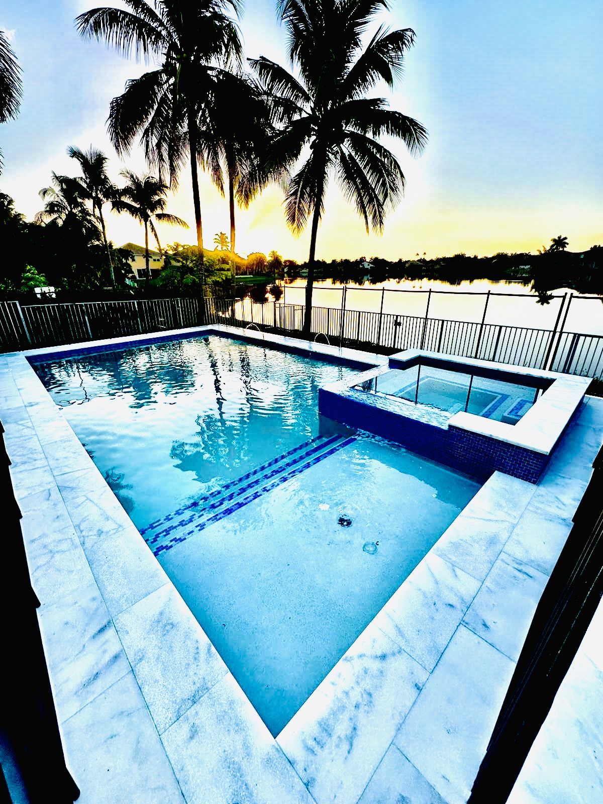 A large swimming pool with palm trees in the background