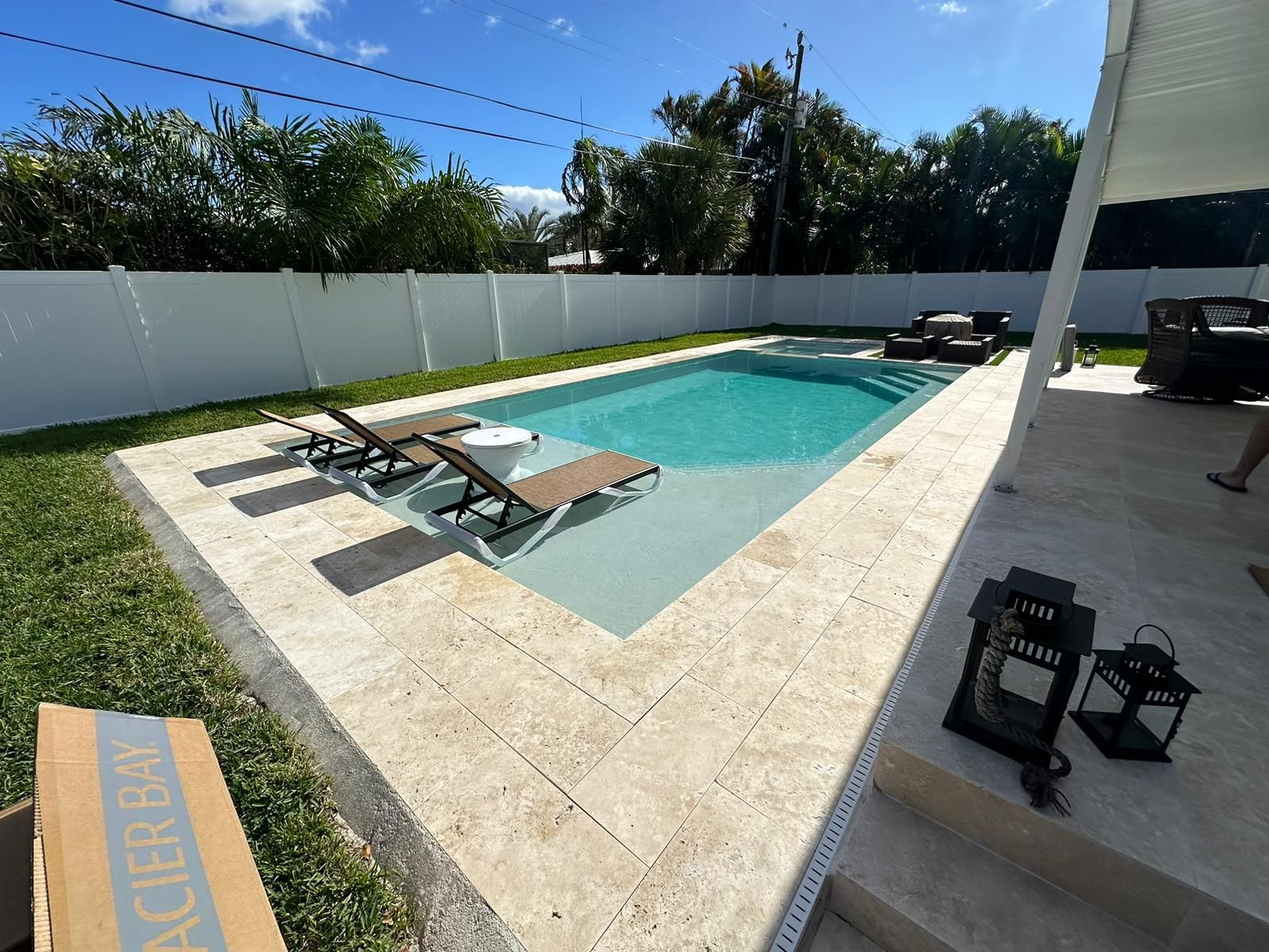 A large swimming pool in the backyard of a house