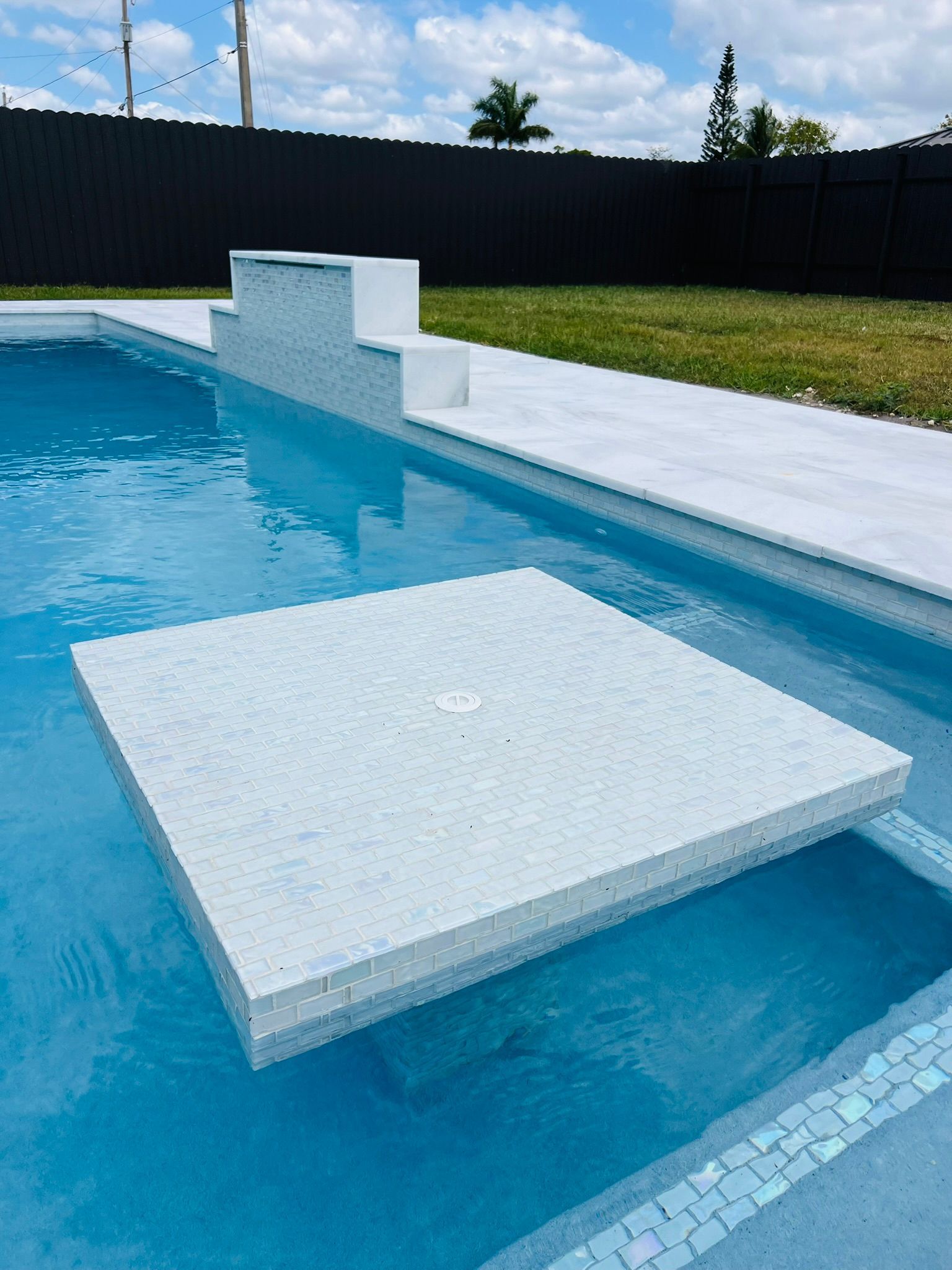A swimming pool with a table in the middle of it.