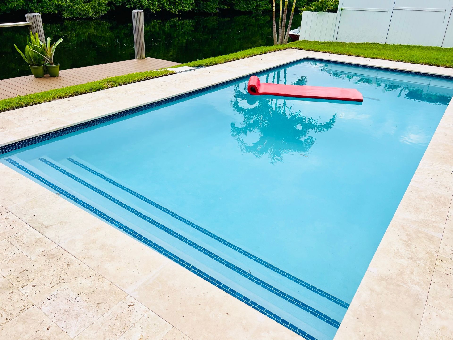 A large swimming pool with a red raft in it