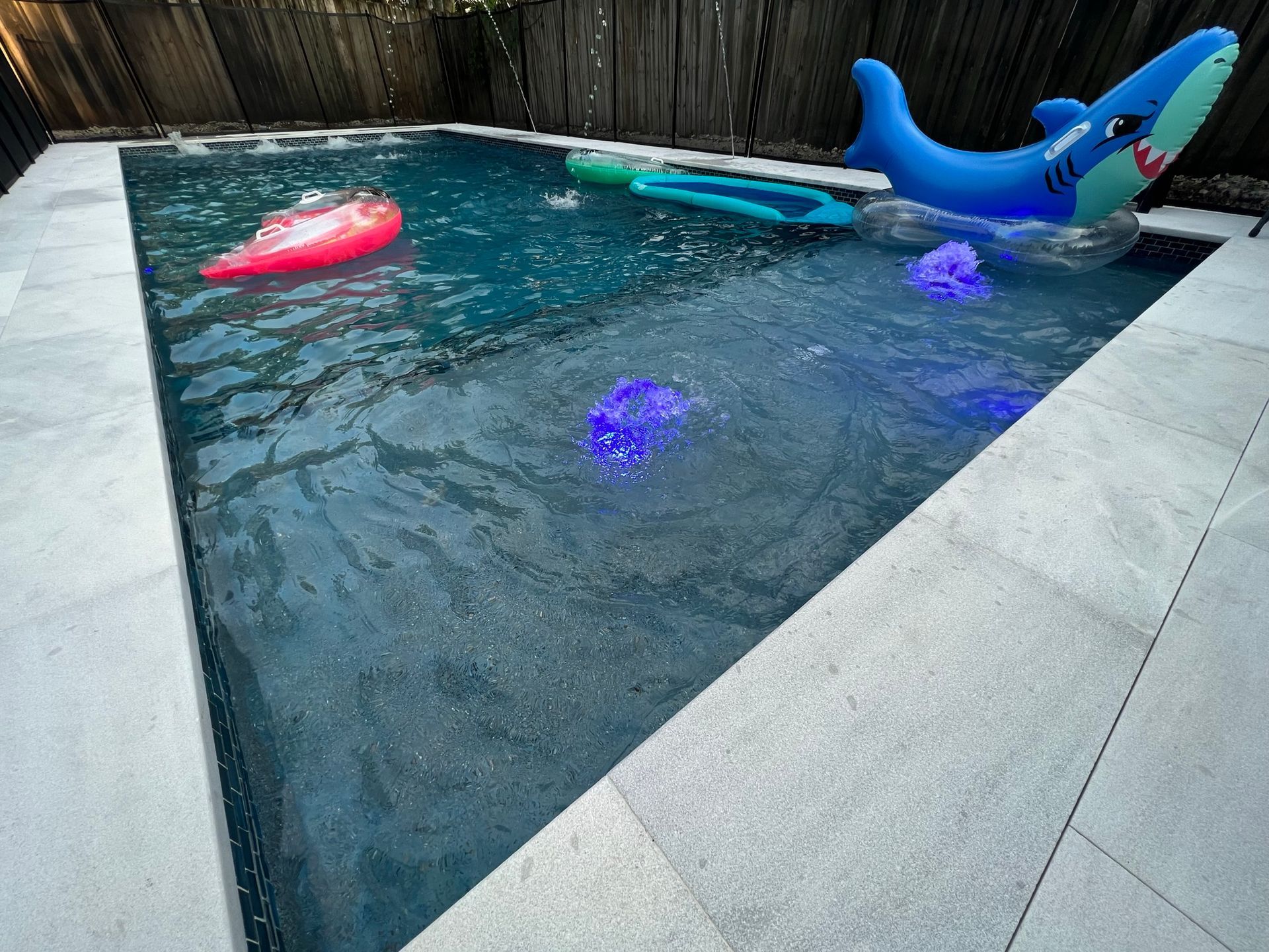 A swimming pool with a shark float in it