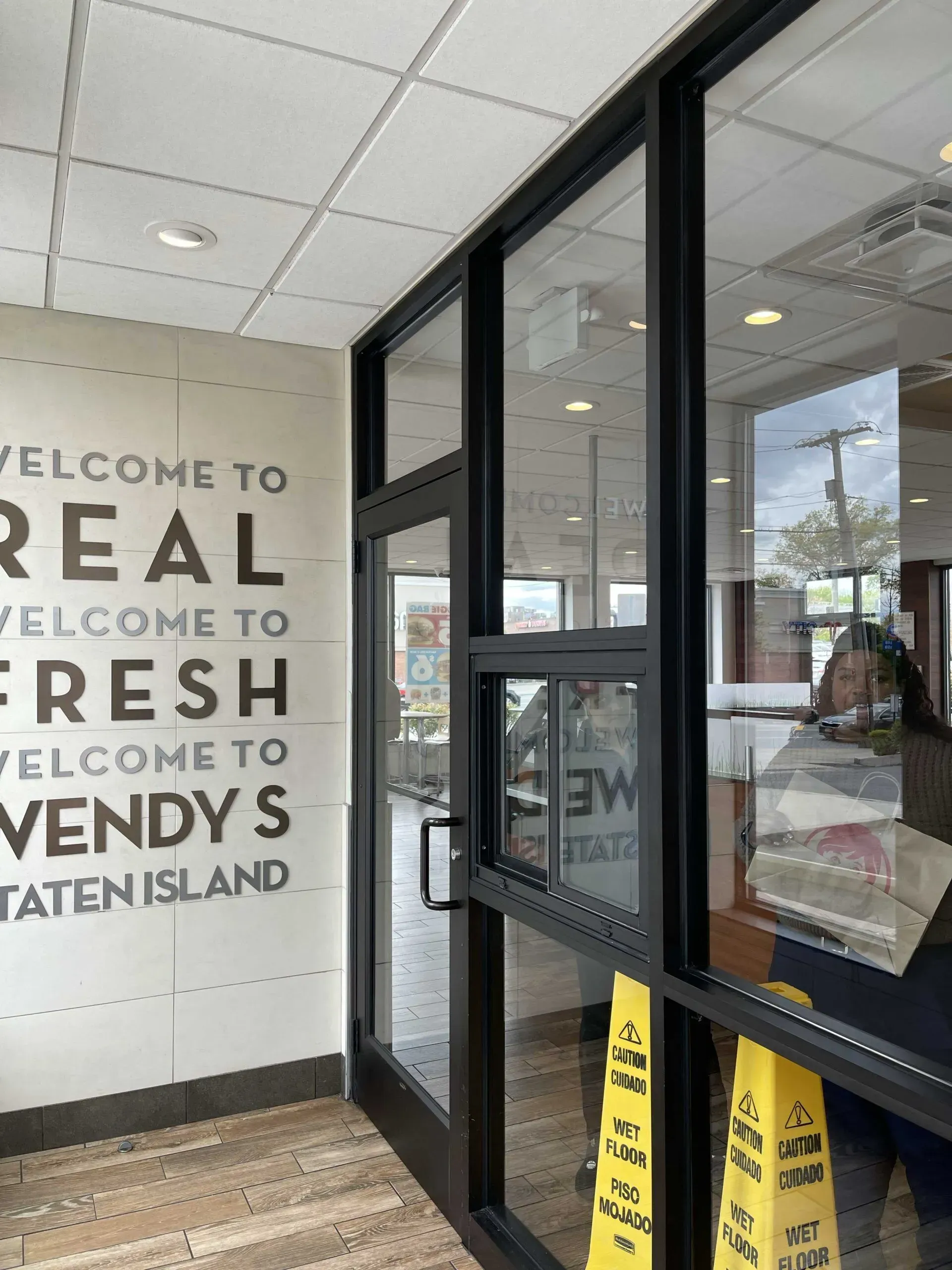A Wendy's restaurant interior features a wall with text reading 