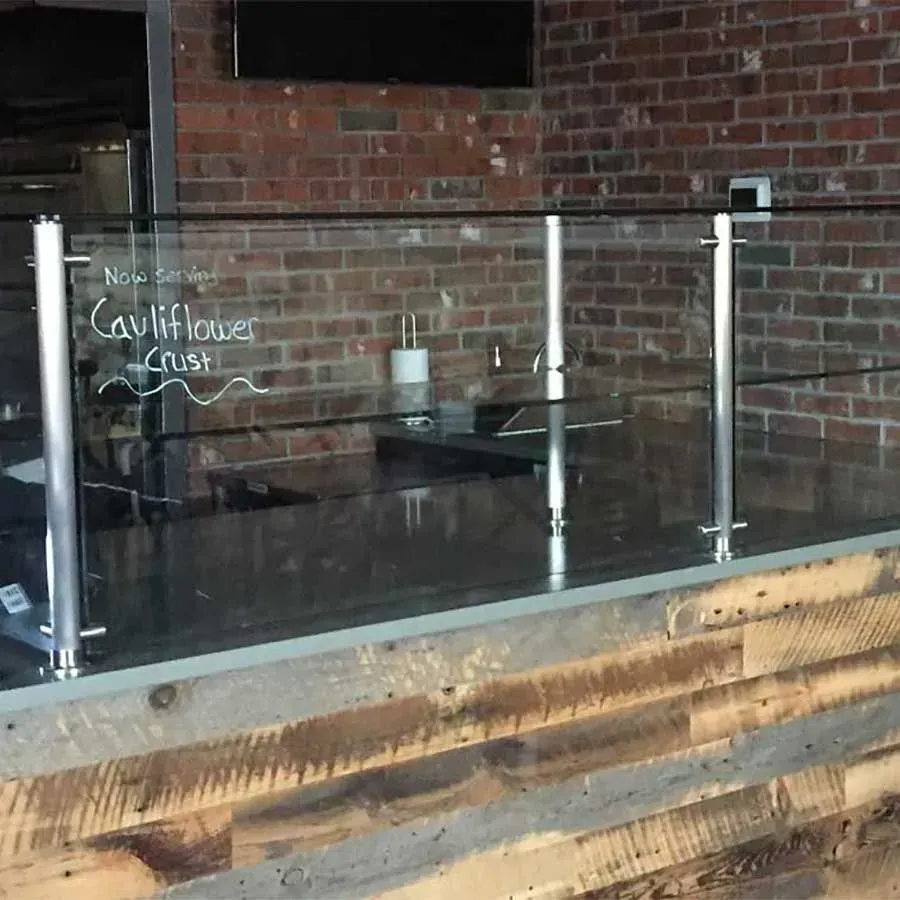 A glass sneeze guard with 