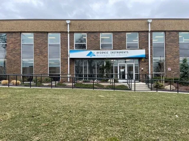 A brick commercial building with a blue and white sign reading 