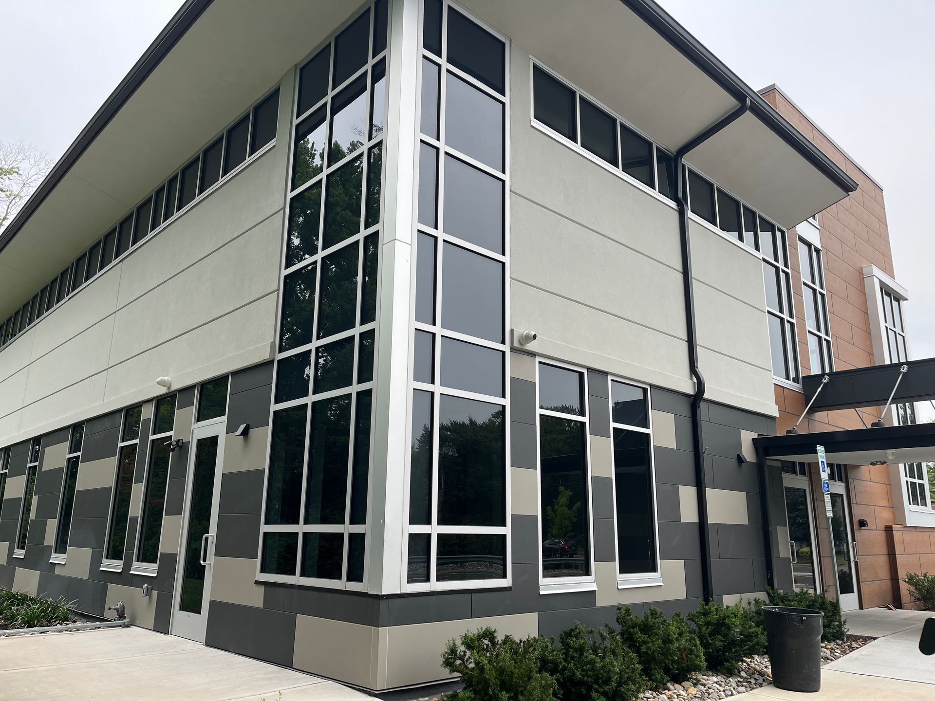 Modern office building with glass corner windows and black-and-white exterior panels