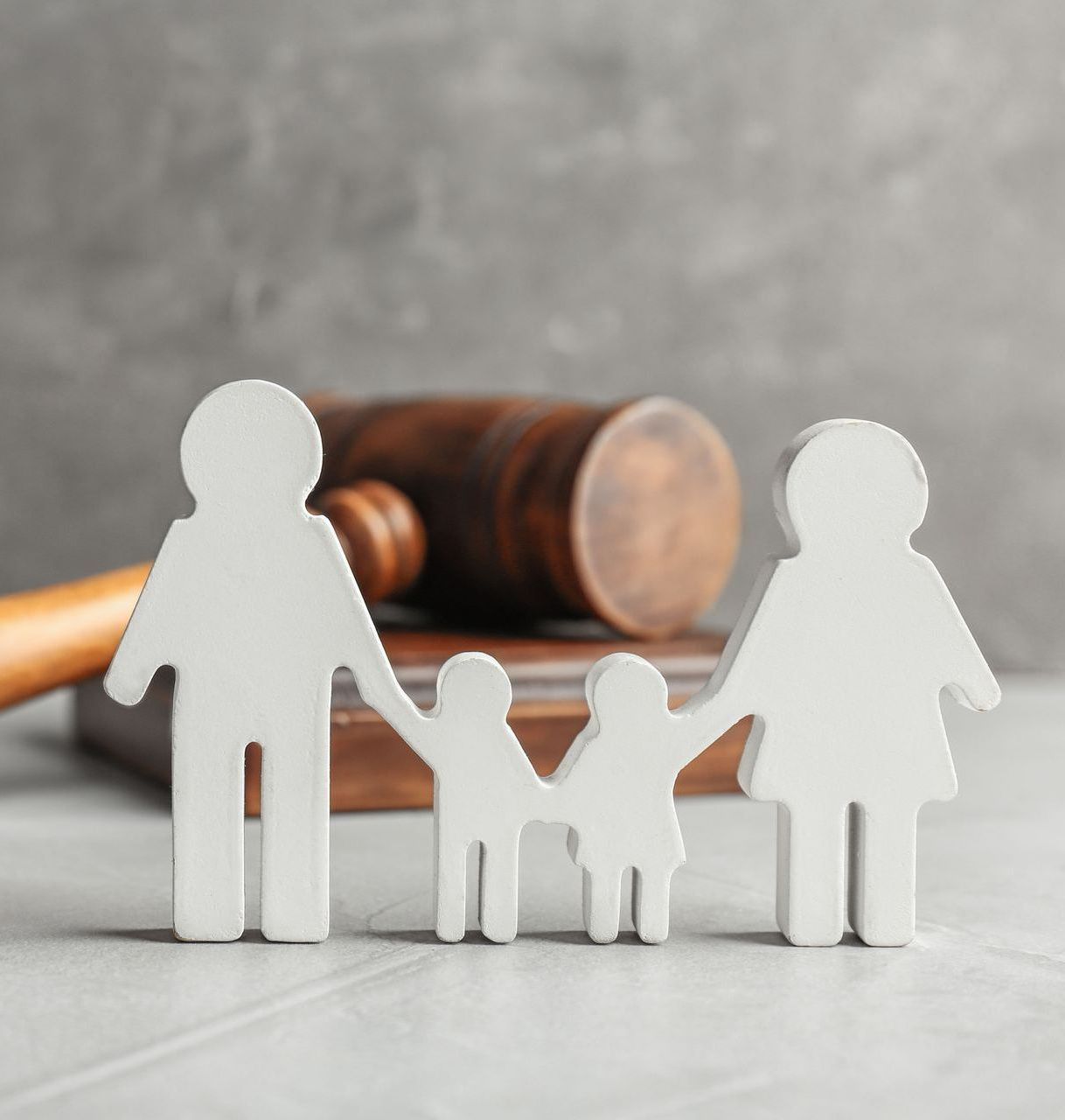 An elderly couple is sitting at a table talking to a woman.