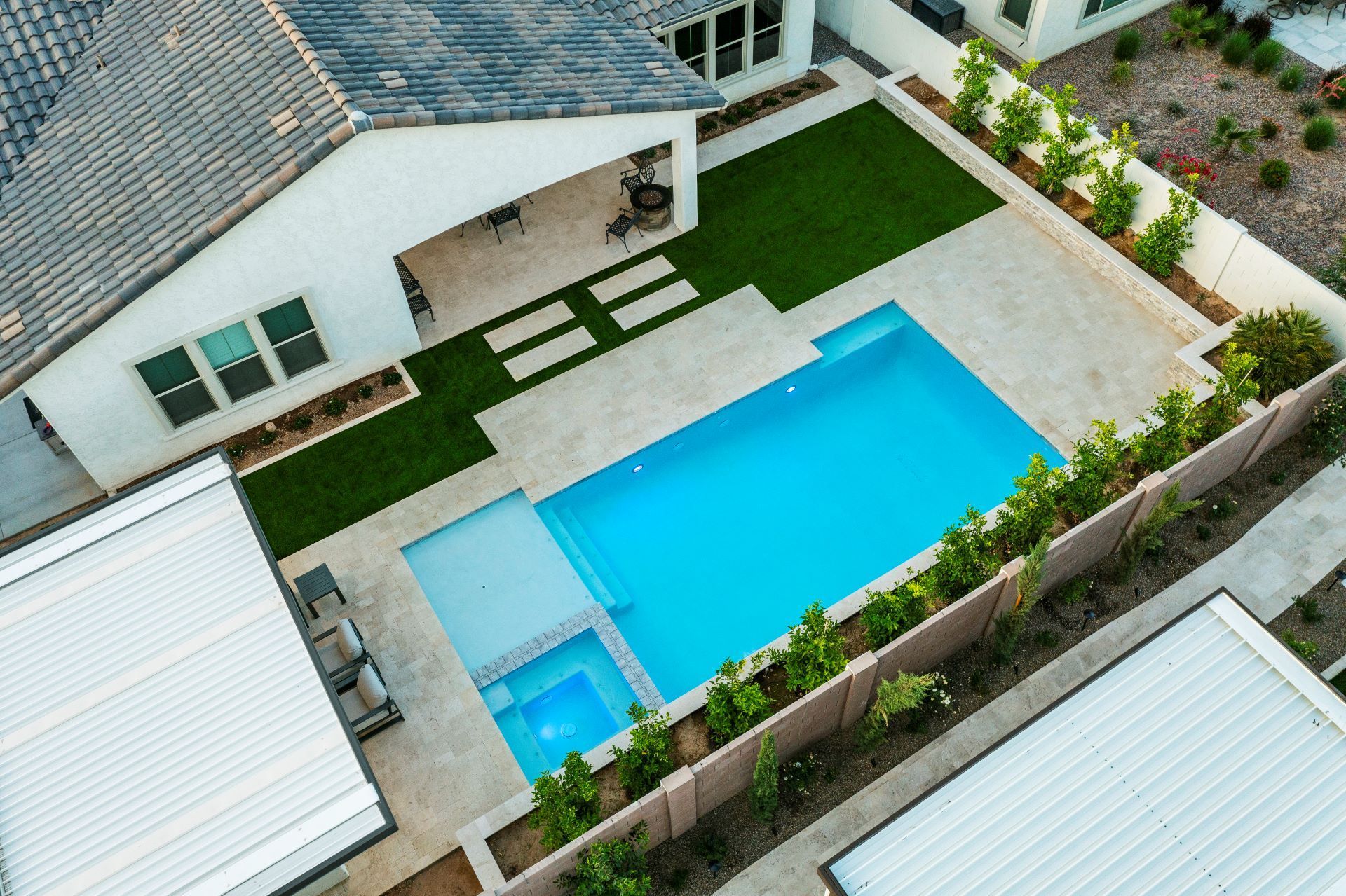 An aerial view of a house with a large swimming pool