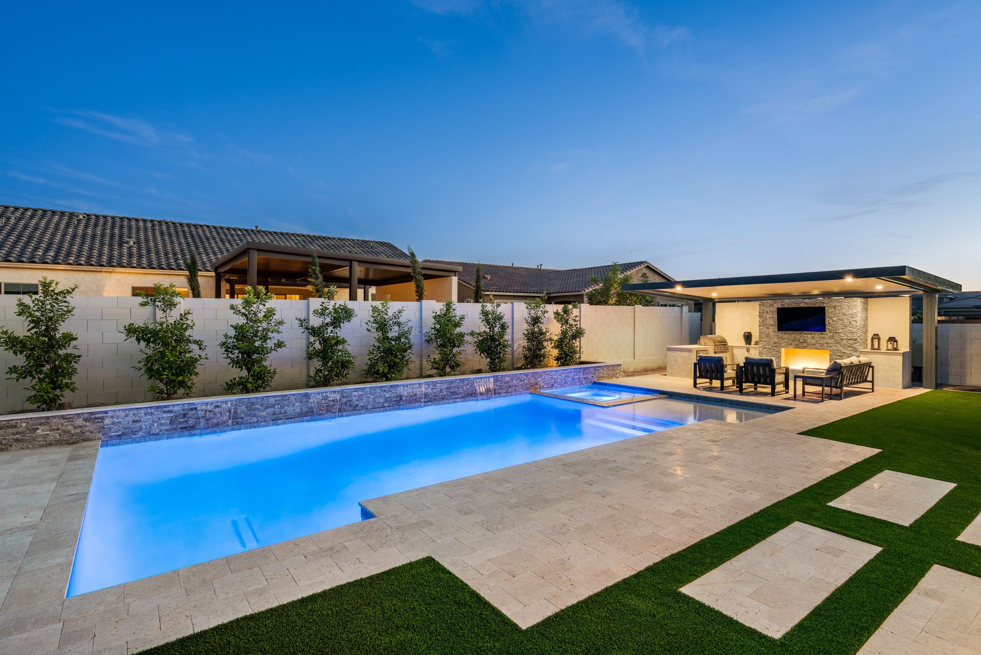 Large, blue swimming pool in the backyard of a house