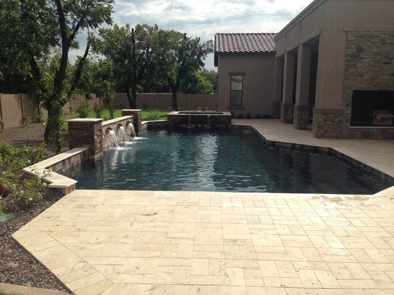 A large swimming pool in the backyard of a house