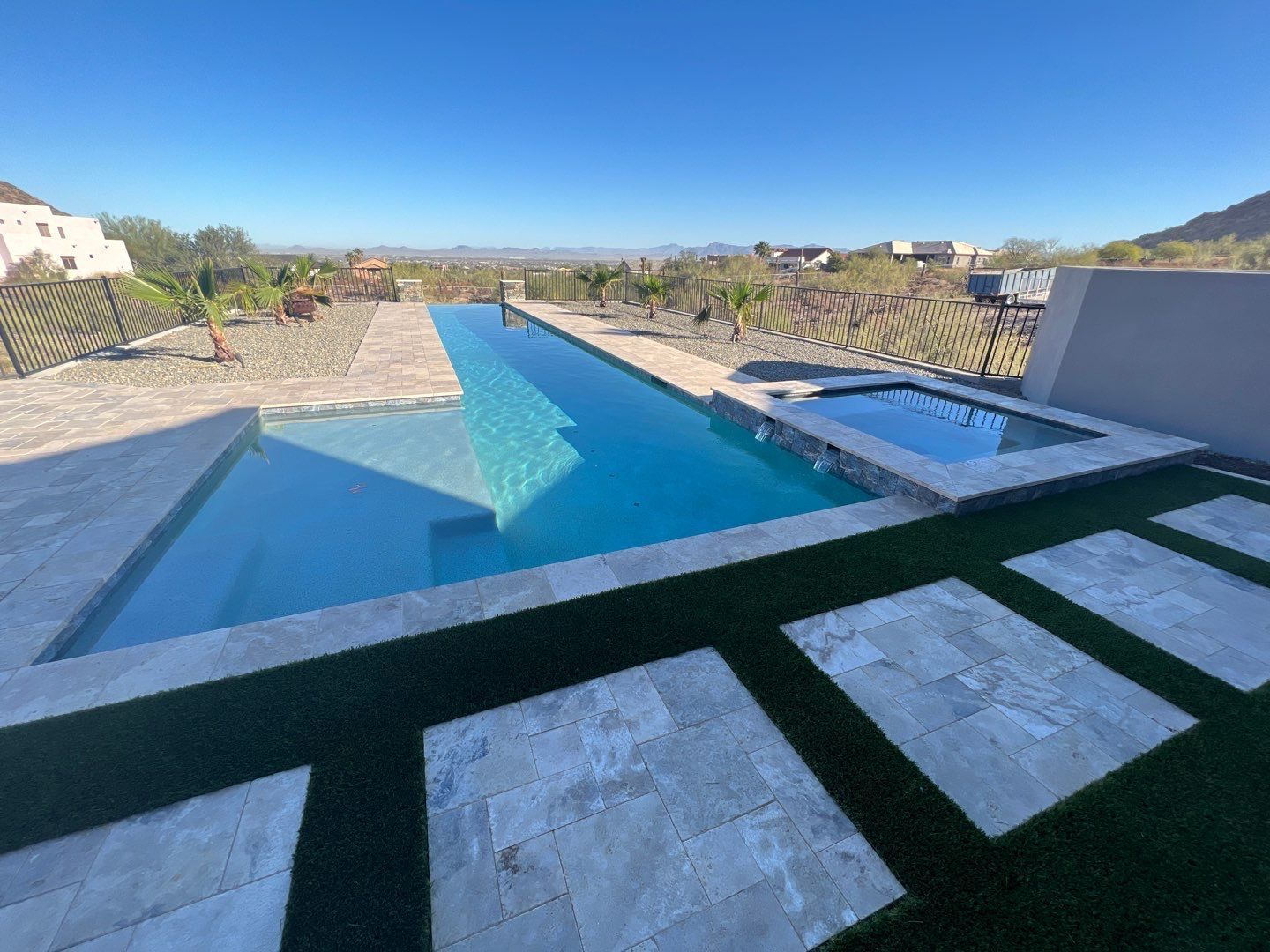 A large swimming pool in the backyard of a house