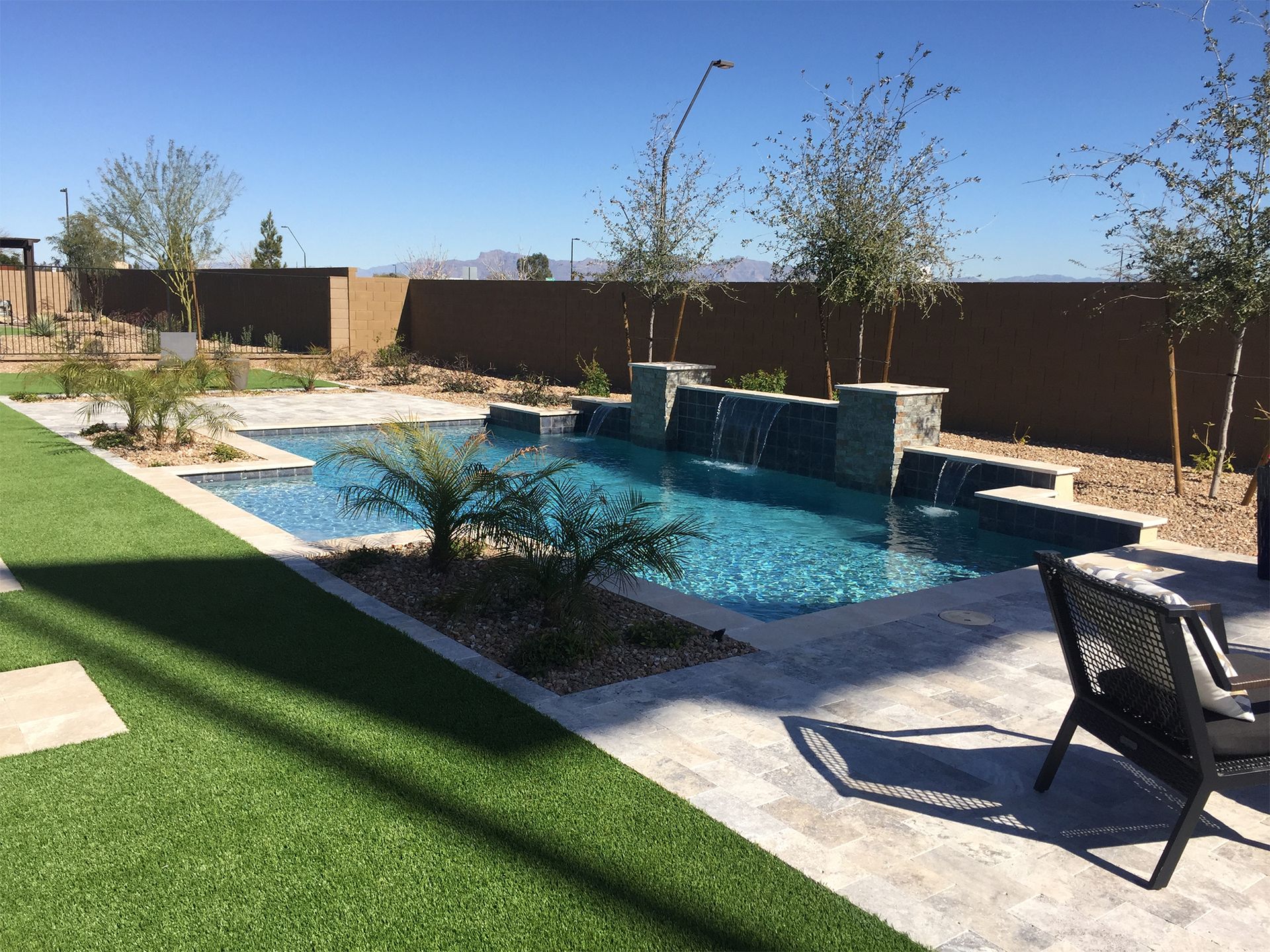 A large swimming pool in the backyard of a house