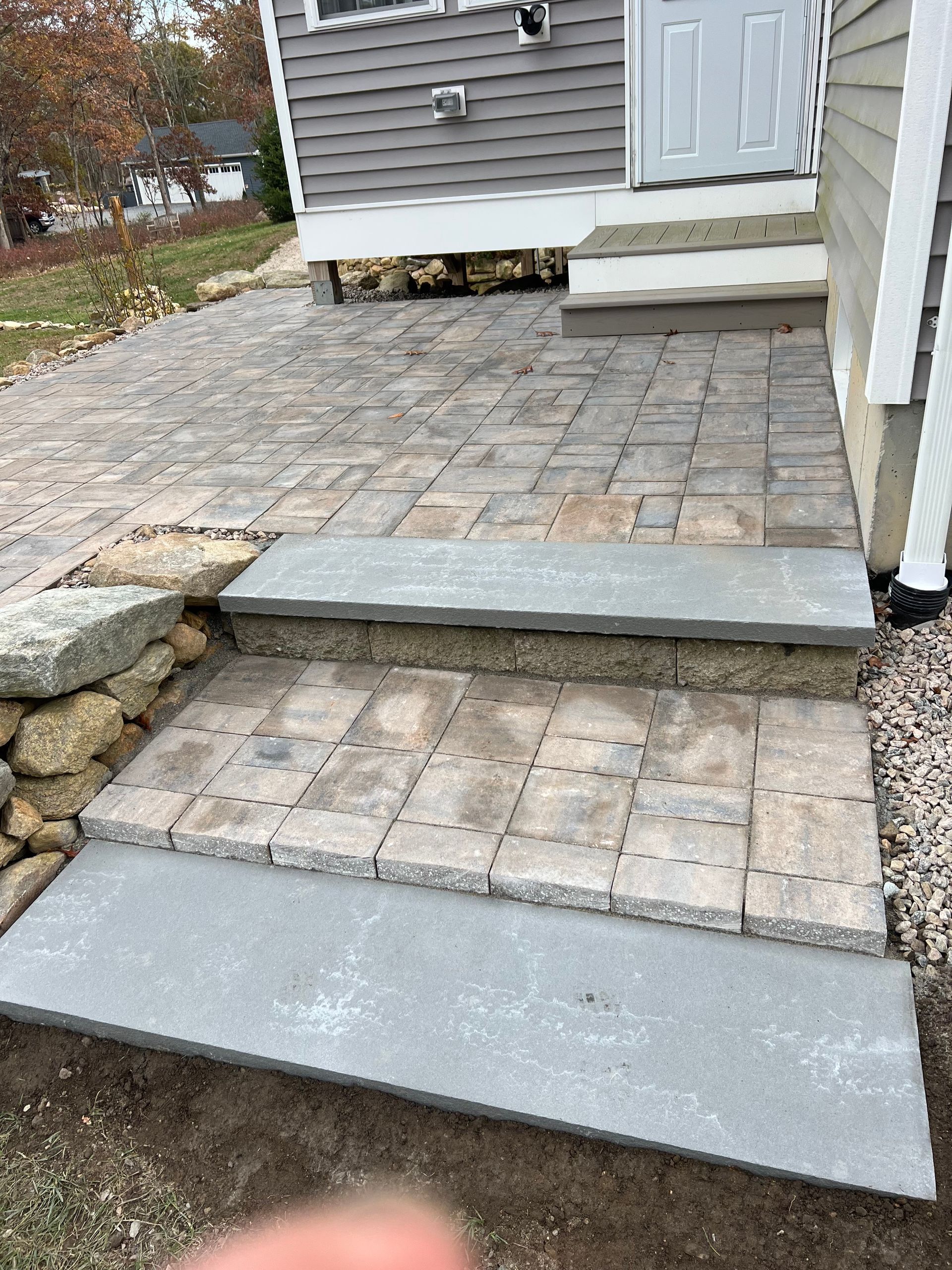 A brick walkway with steps leading up to a house.