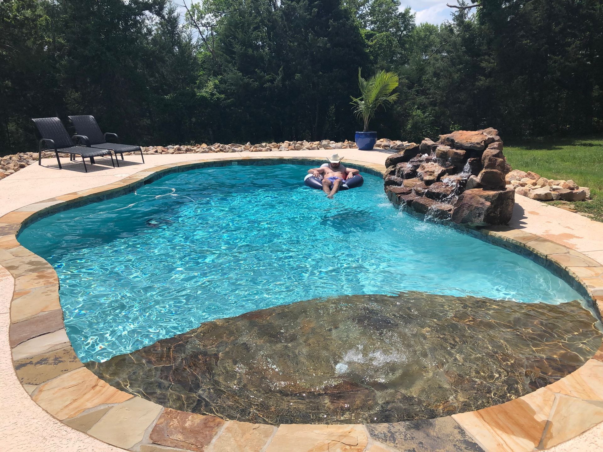 A person is floating on a raft in a swimming pool.