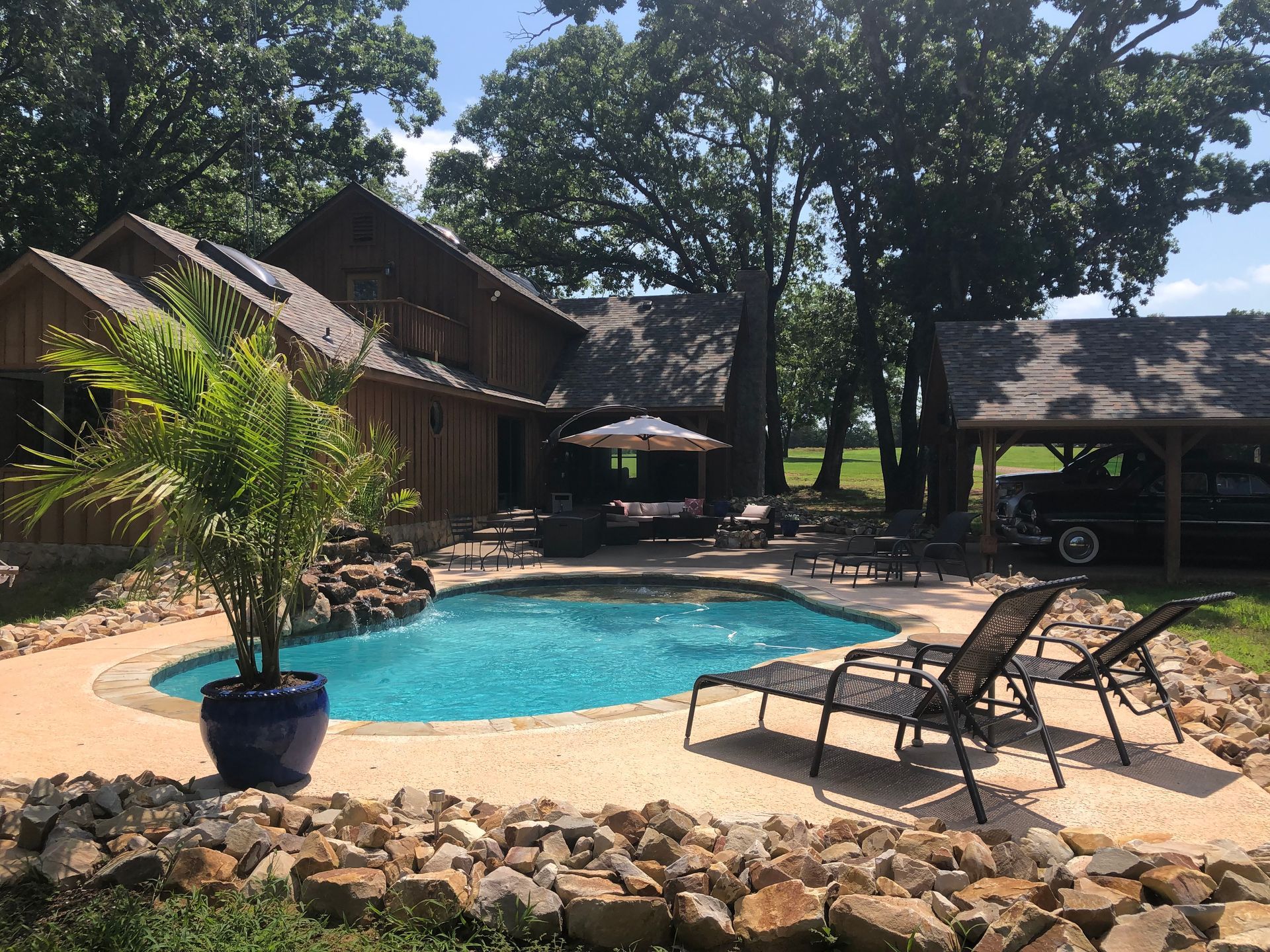 A large house with a swimming pool in front of it