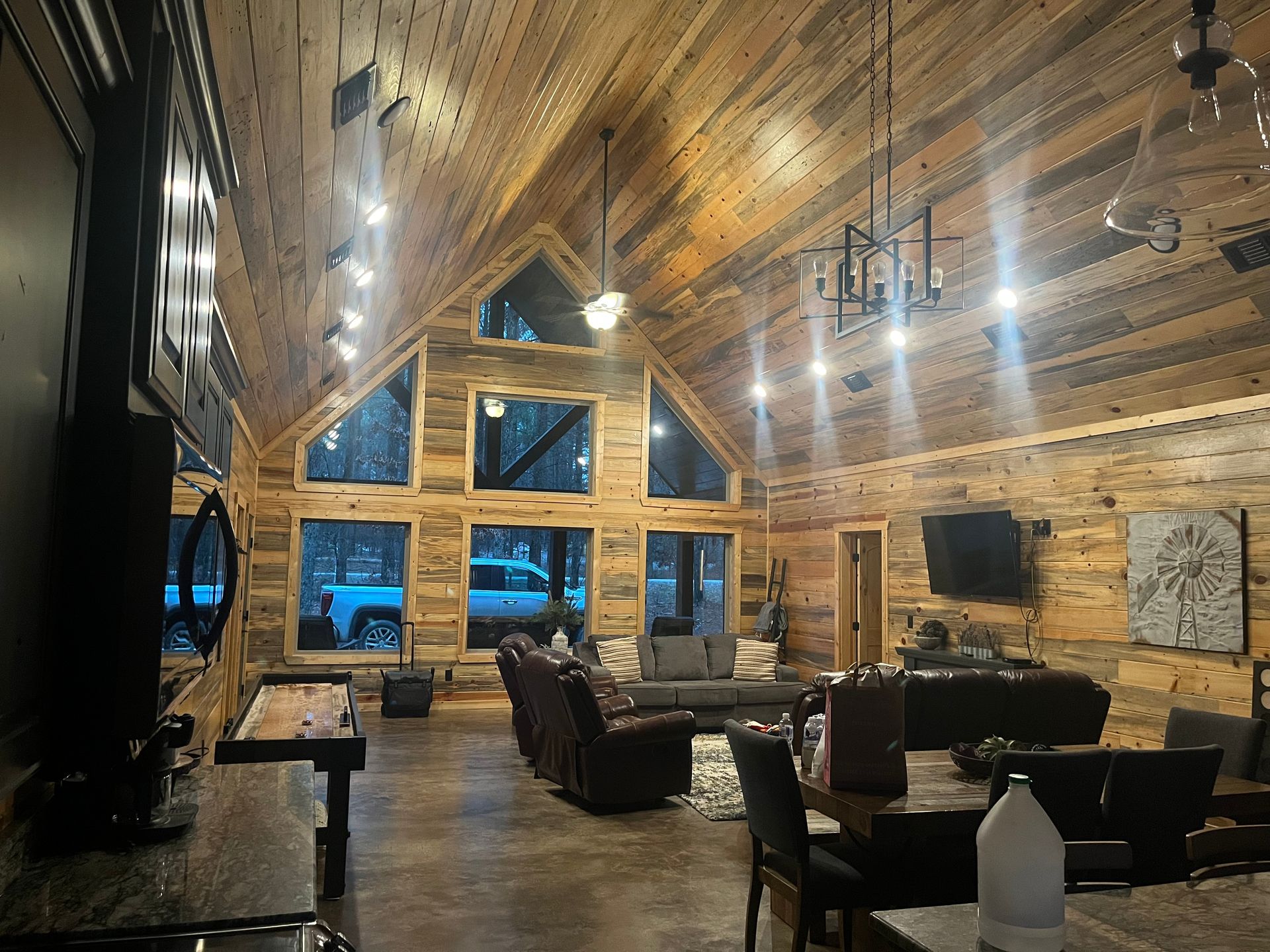 A large living room in a log cabin with a lot of furniture.