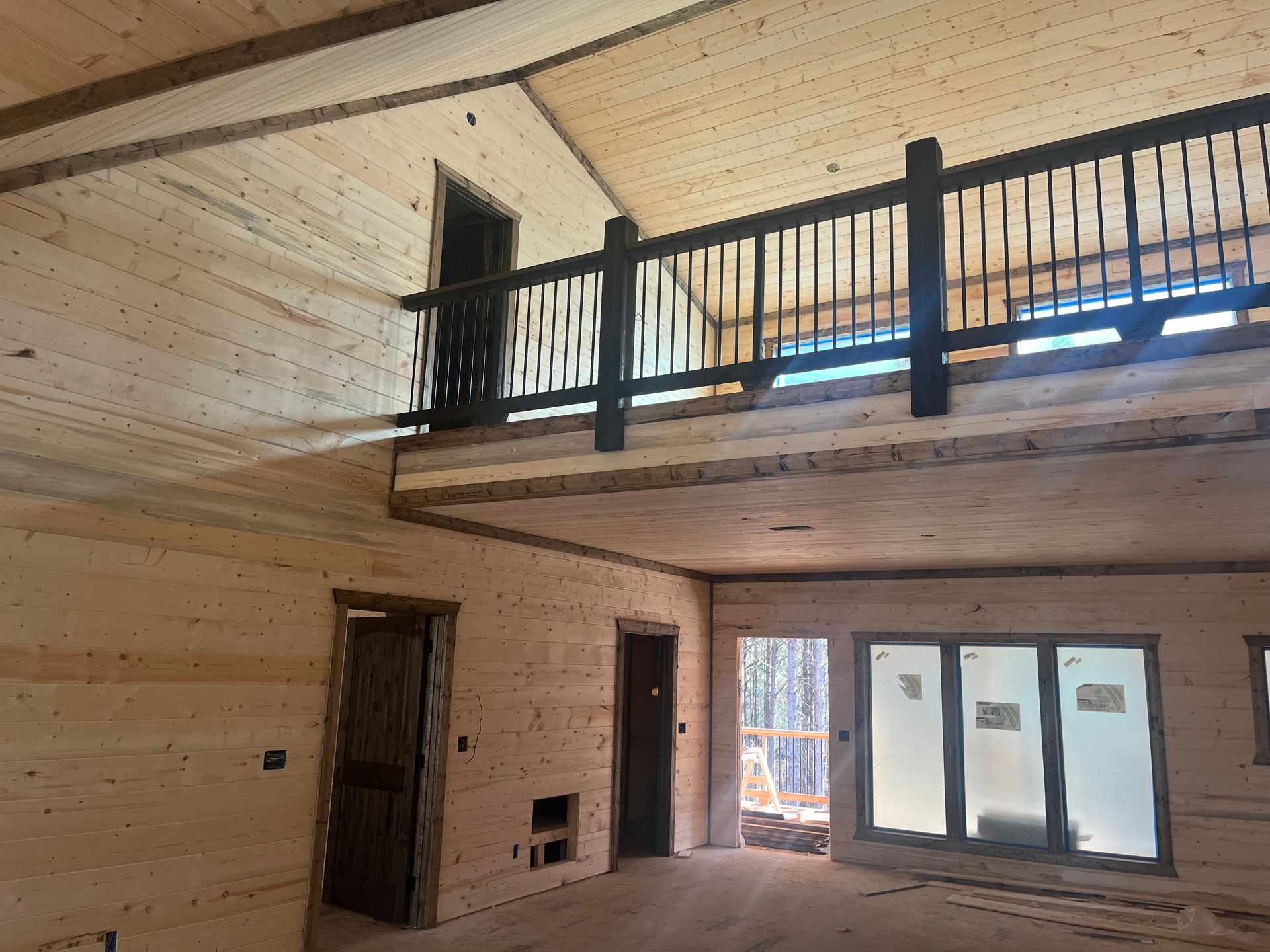 A wooden house with a balcony and stairs