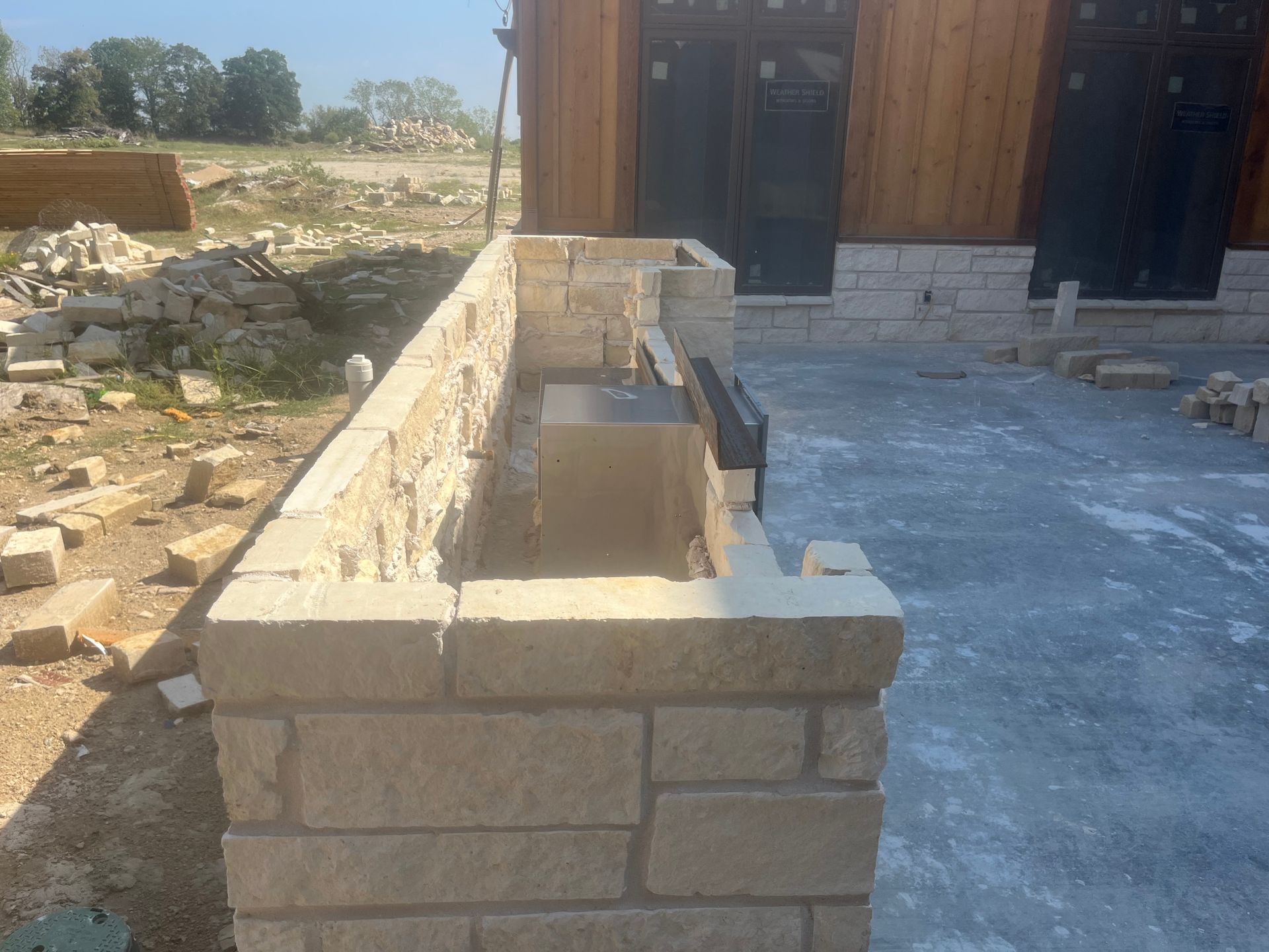 A brick wall is being built in front of a building.