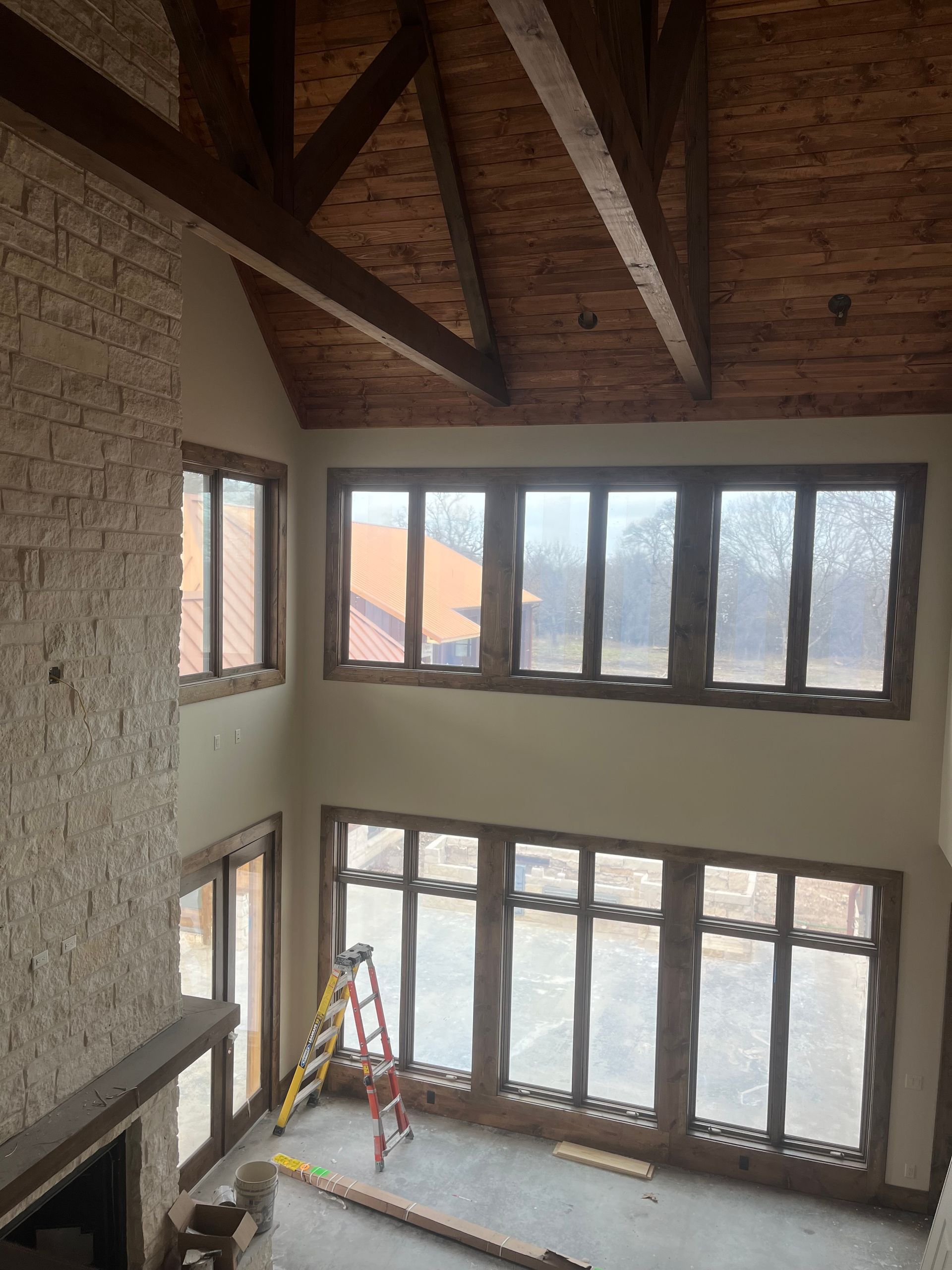 A large room with a lot of windows and a ladder in the middle.