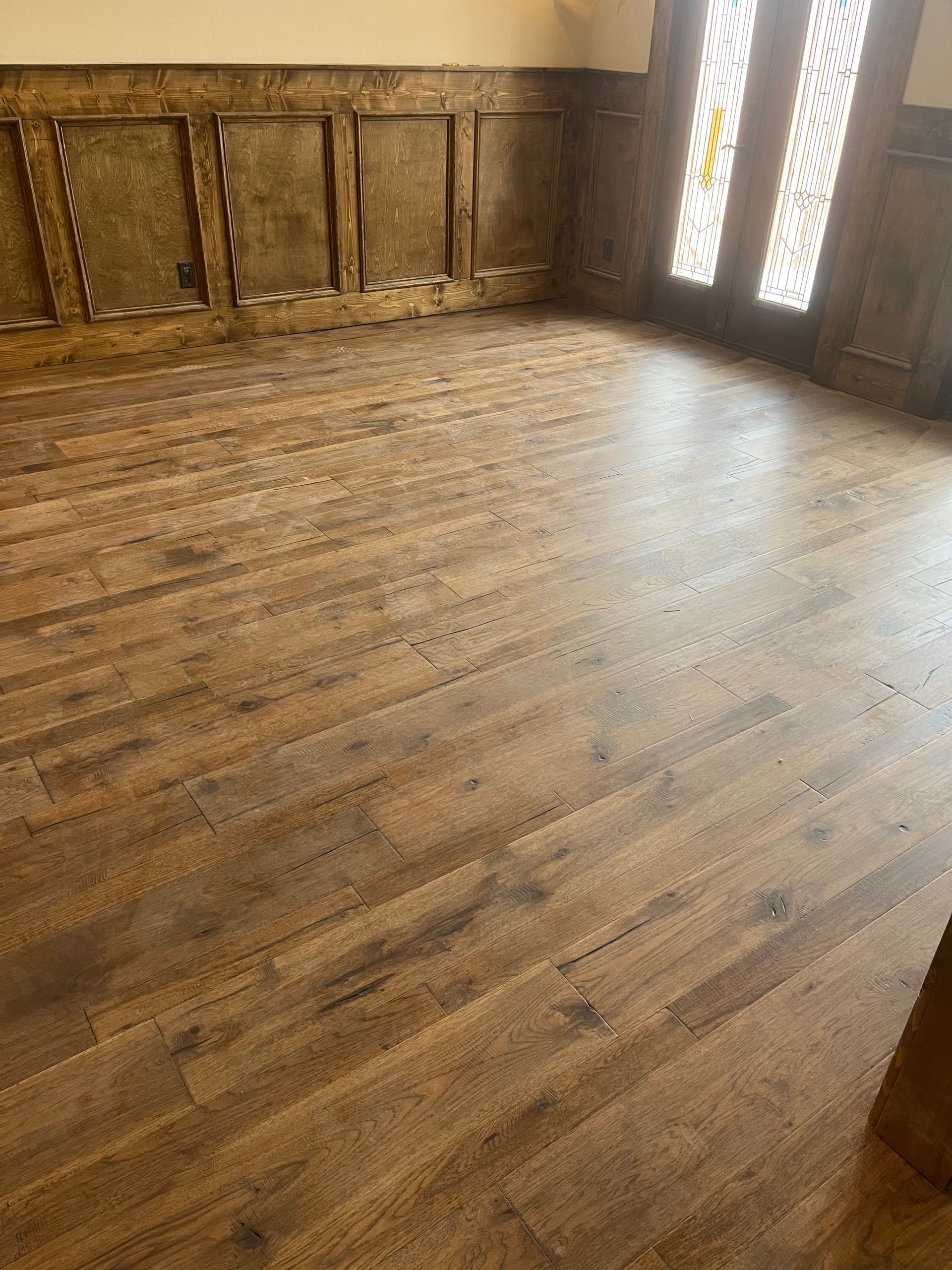 A room with a wooden floor and a door.