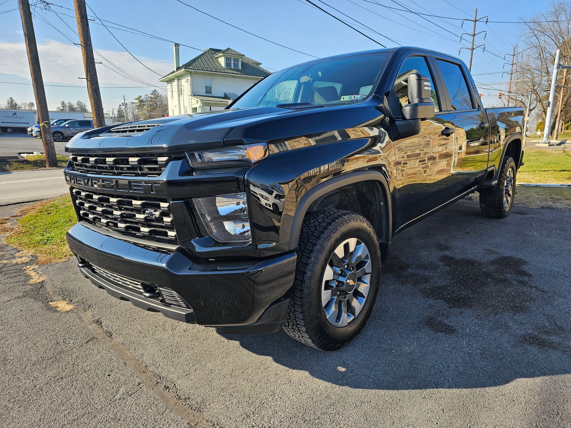Black Chevrolet pickup truck parked on asphalt.