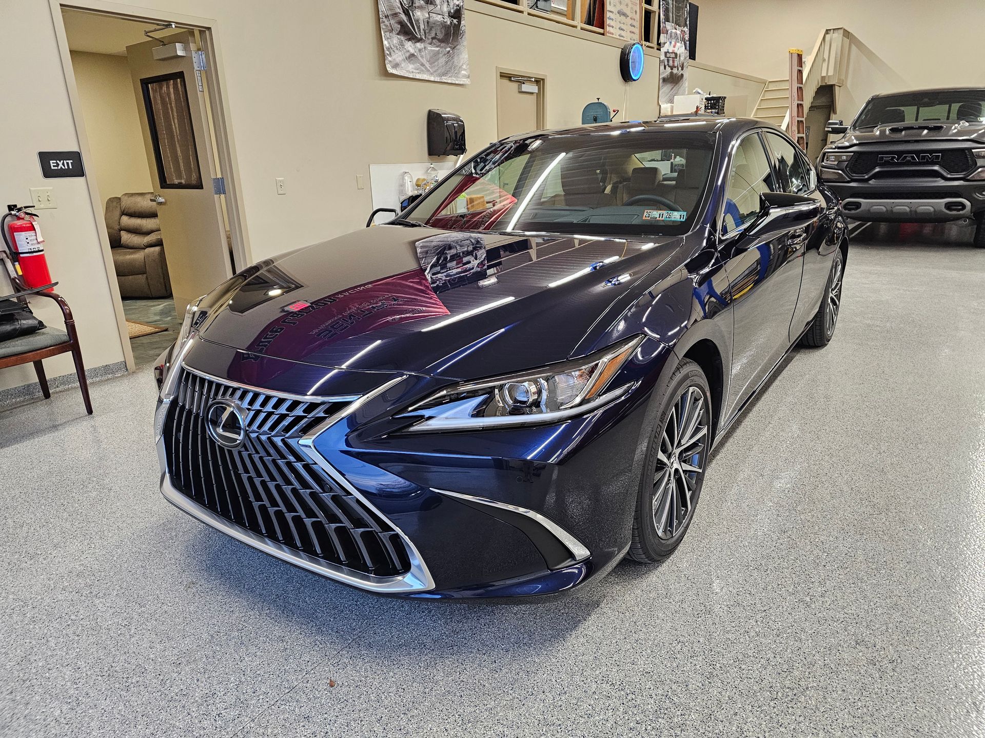 Dark blue Lexus sedan in a showroom.
