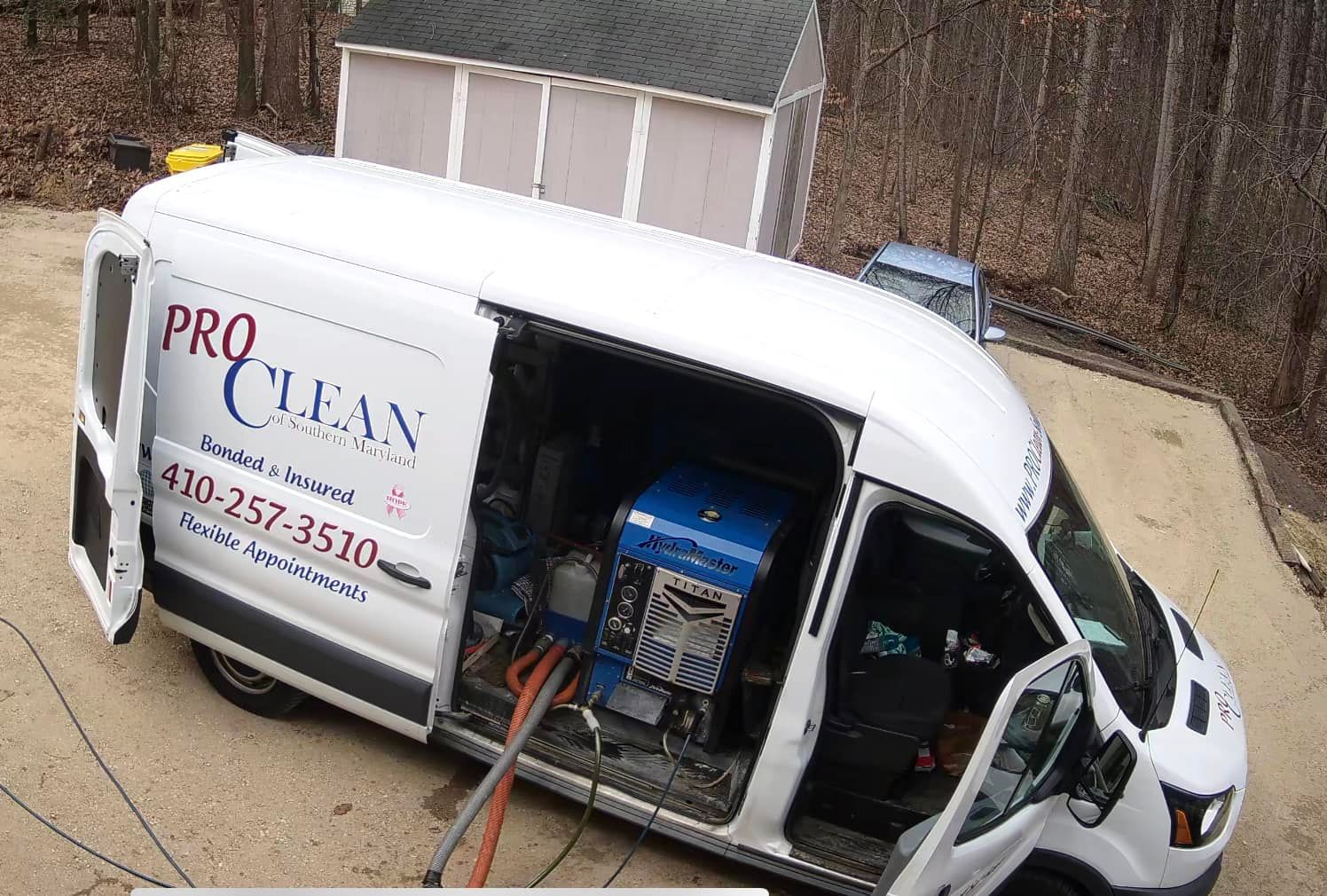 A white pro clean van is parked in a driveway.