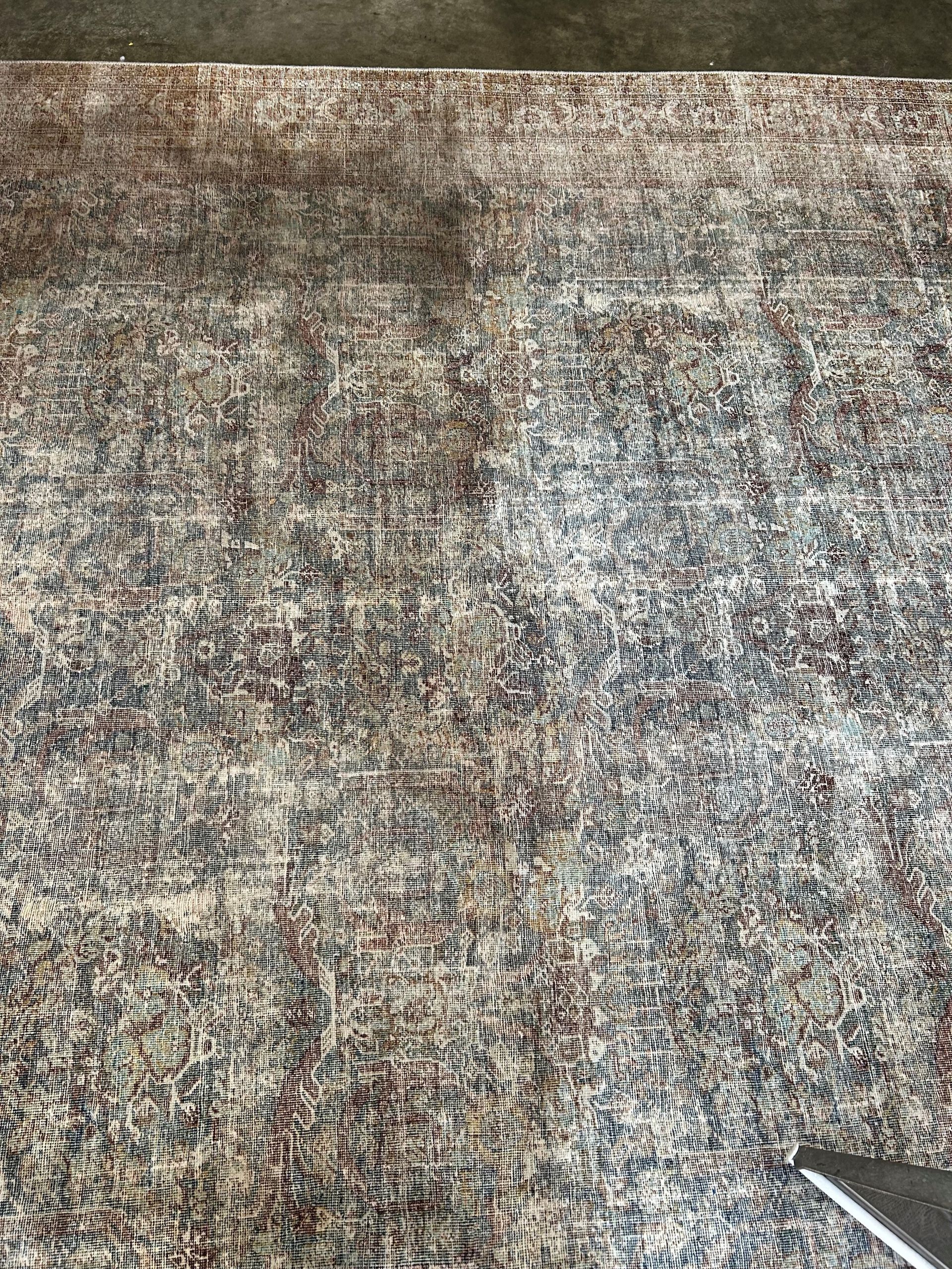 A close up of a rug being cleaned with a vacuum cleaner.