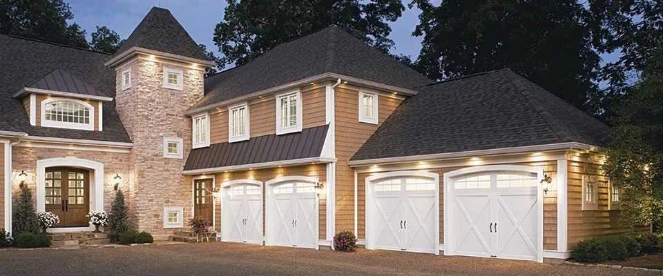 A large brick house with a lot of garage doors