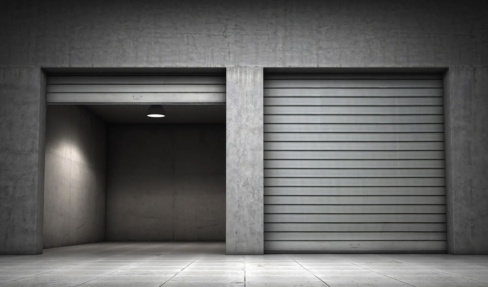 A concrete garage with two garage doors open.