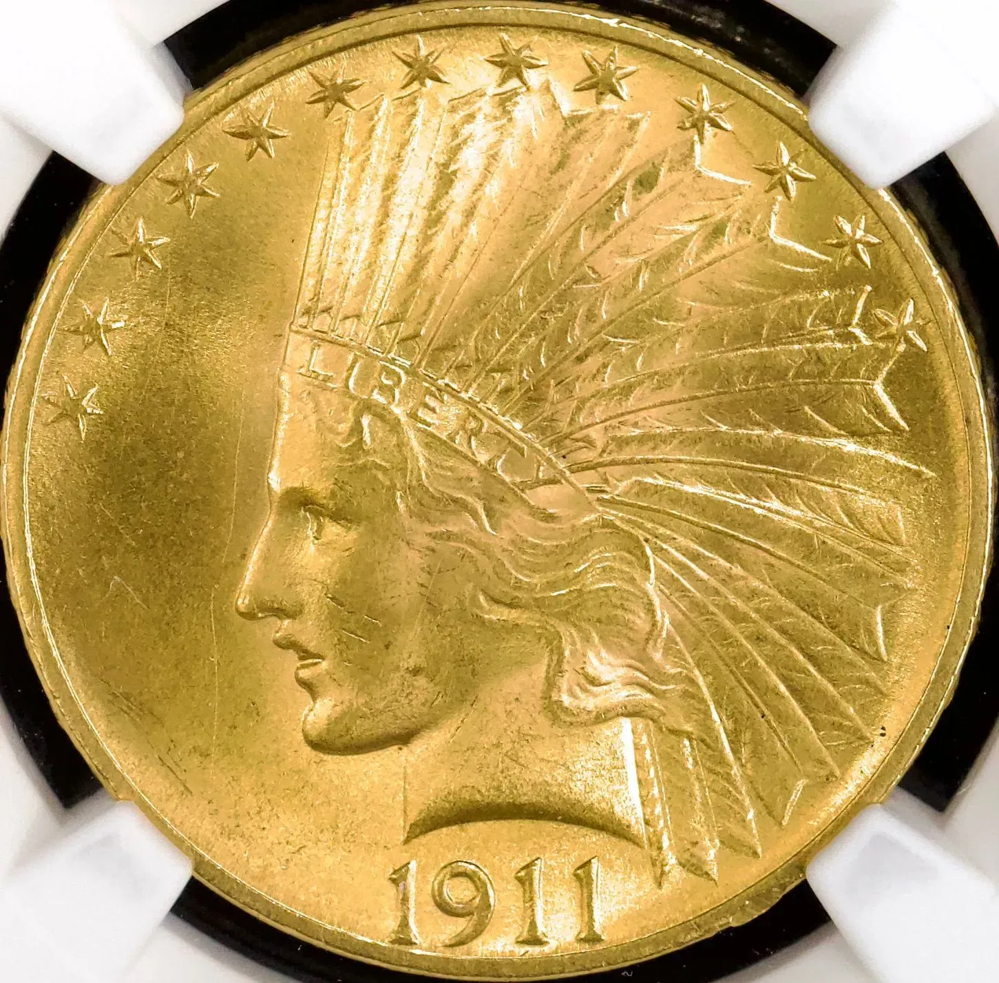 Gold 1911 coin with a left-facing Native American head profile and feathered headdress