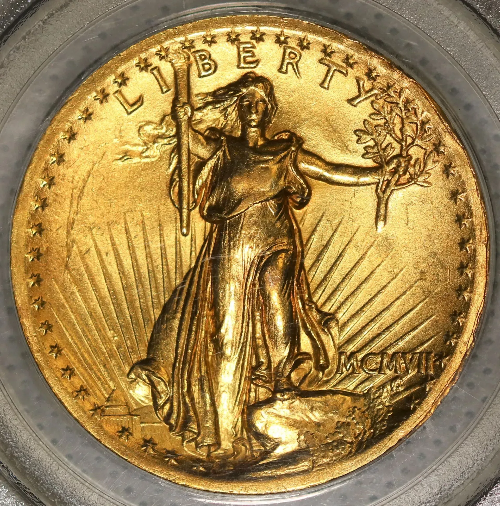 Gold coin with Liberty holding torch and olive branch on a sunburst background