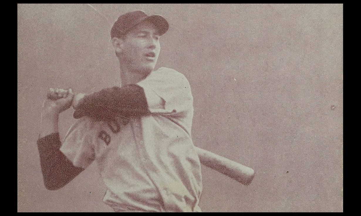 Sepia-toned baseball player preparing to swing, holding a bat over his shoulder.
