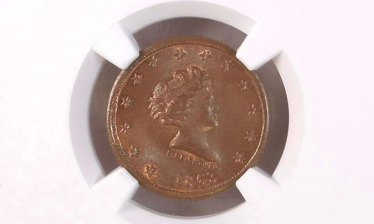 Copper coin in a white and gray coin holder, showing a profile portrait.